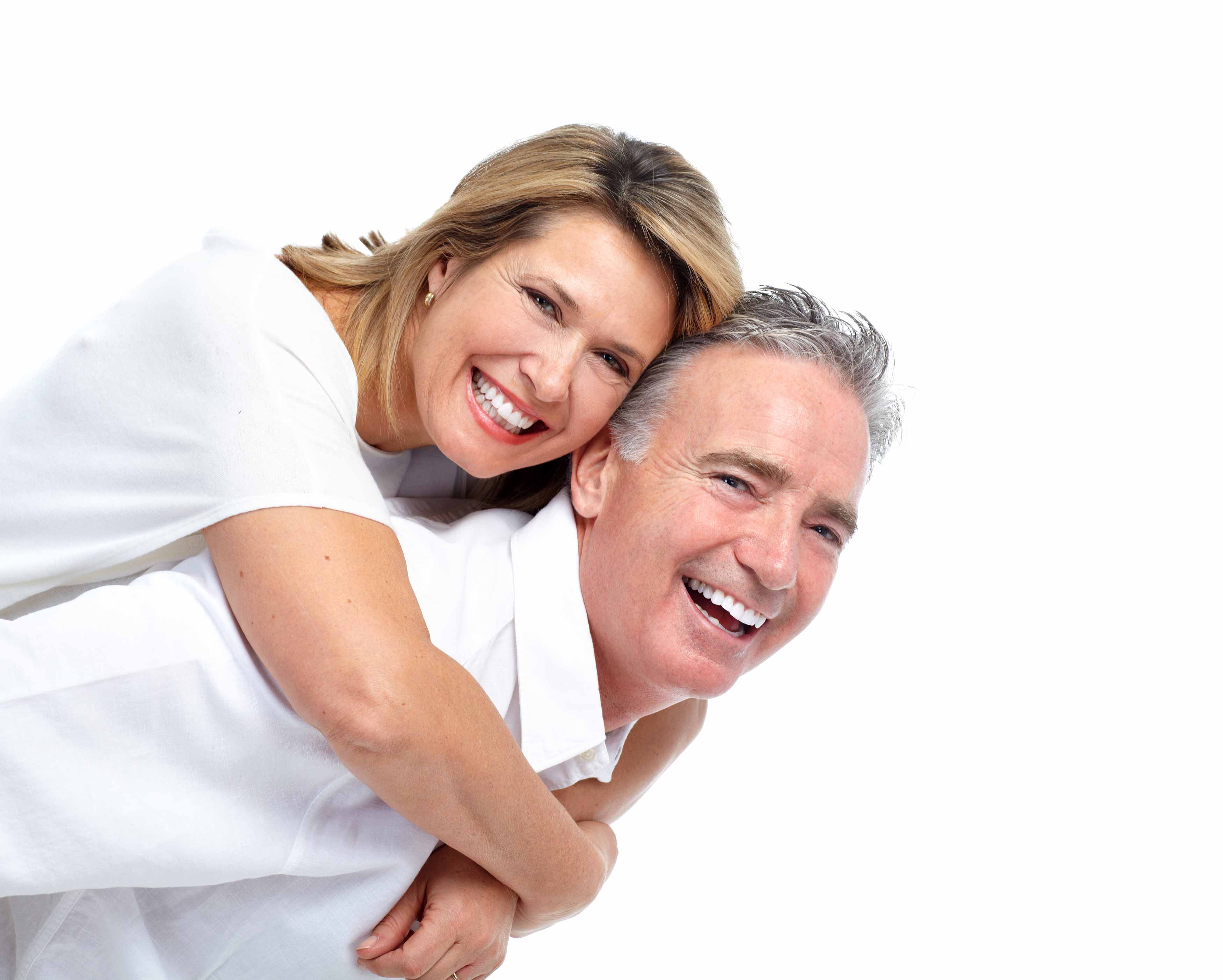 Photo of a middle aged couple where the female is hugging the back of the male