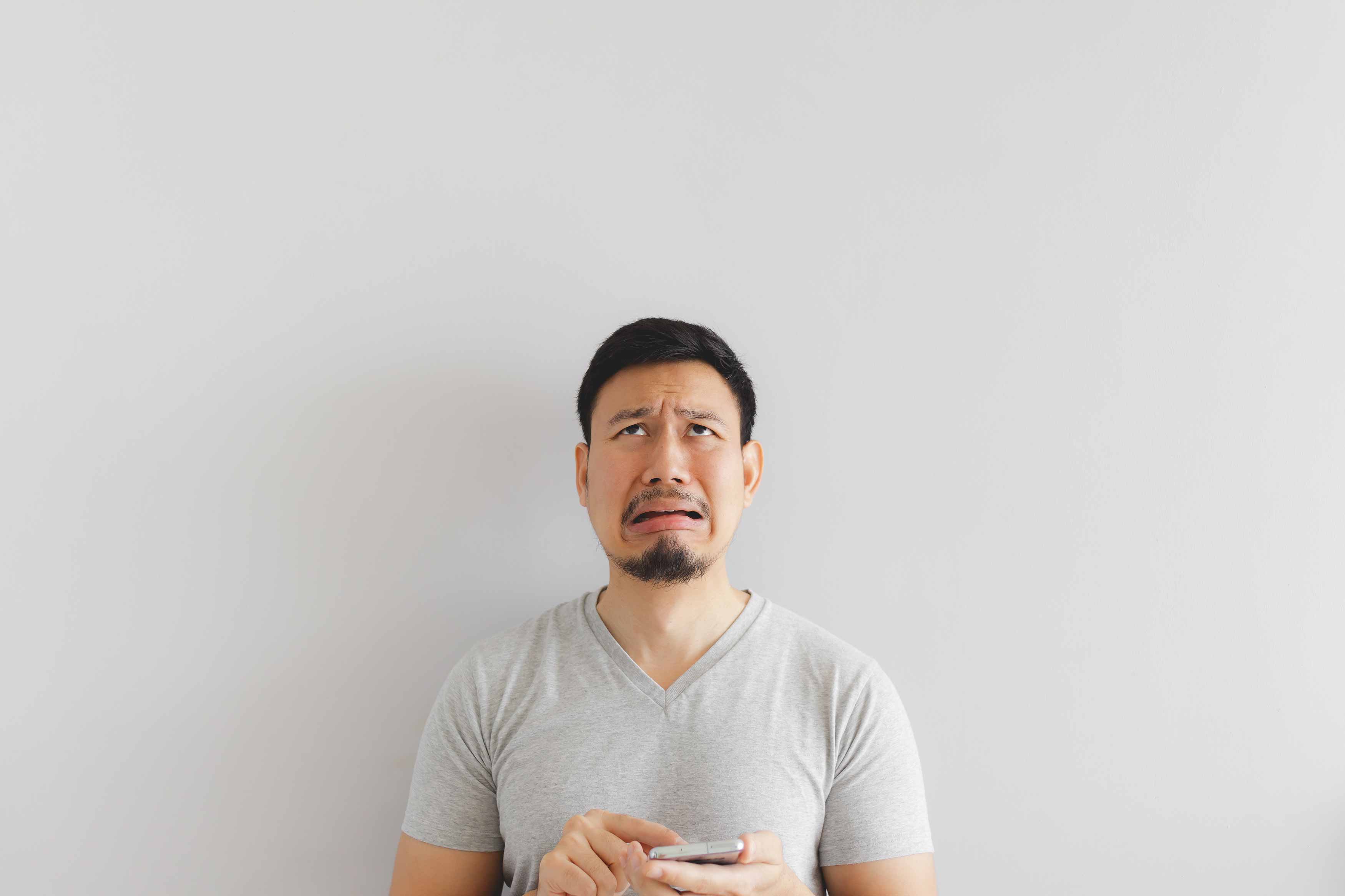 Photo of a young lady covering her mouth with both hands indicating that her breath stinks
