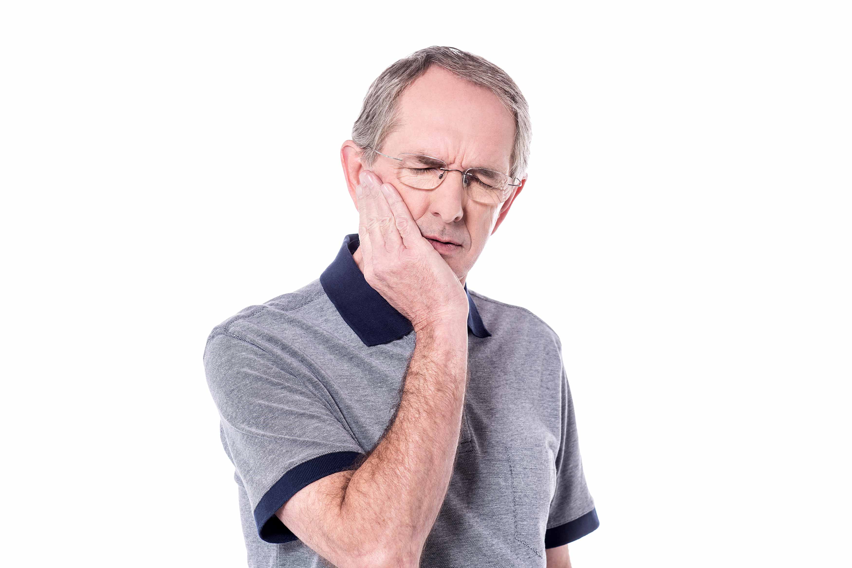 Photo of a man holding his jaw in pain 
