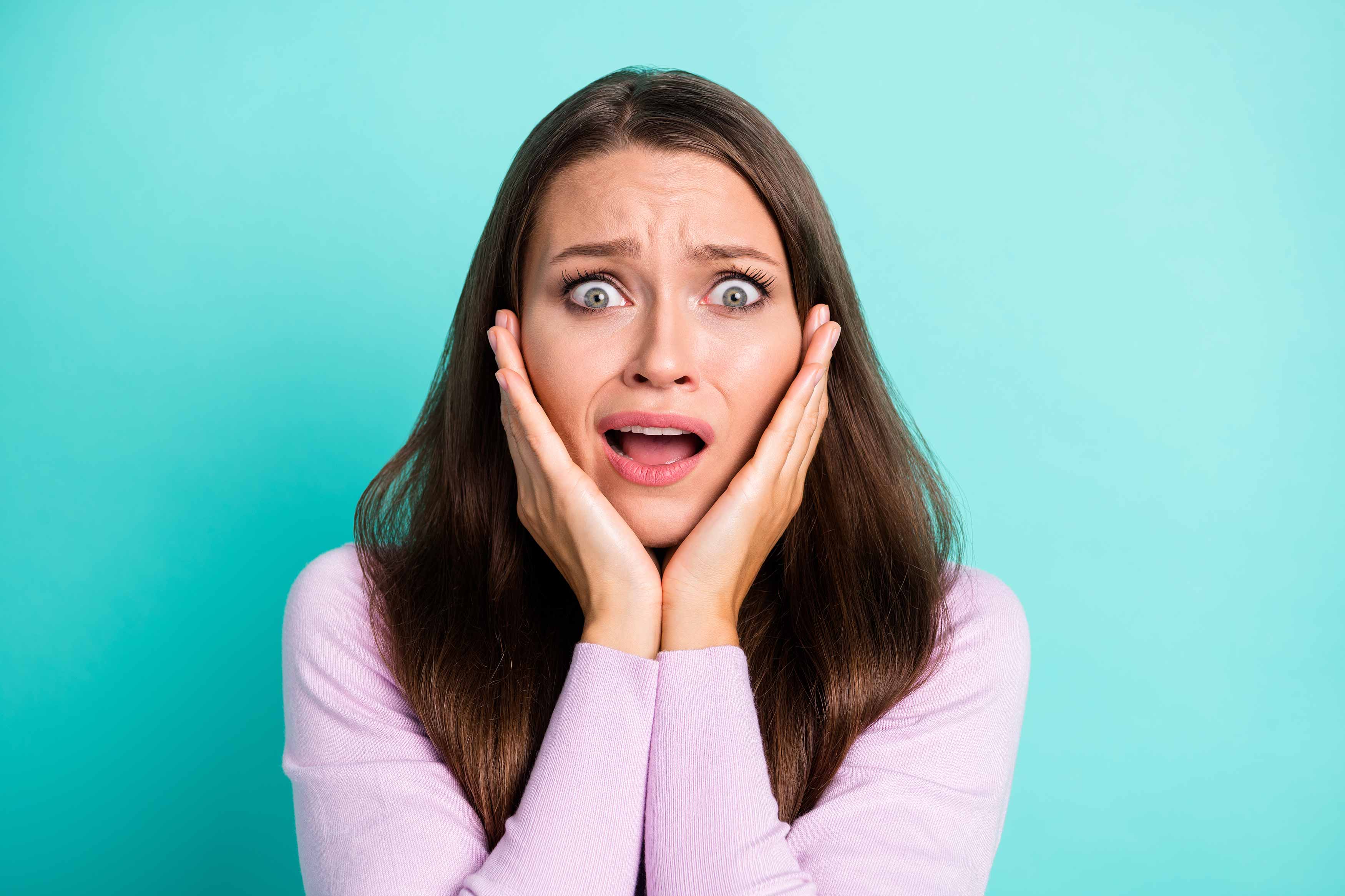 midbody of a female holding her face in shock because of bad breath