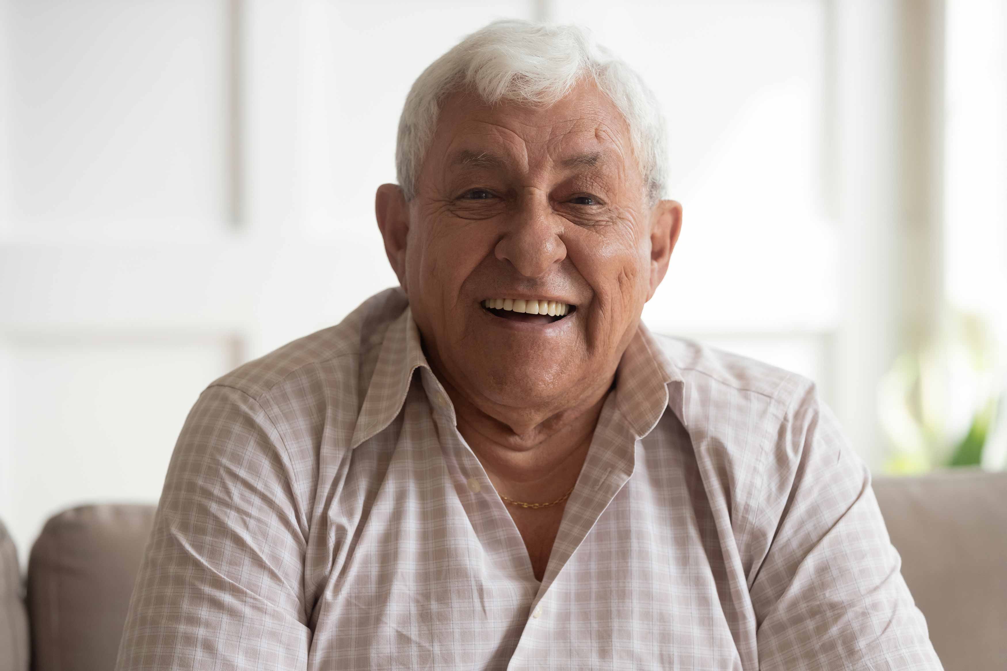 Photo of an older male smile with his upper full denture