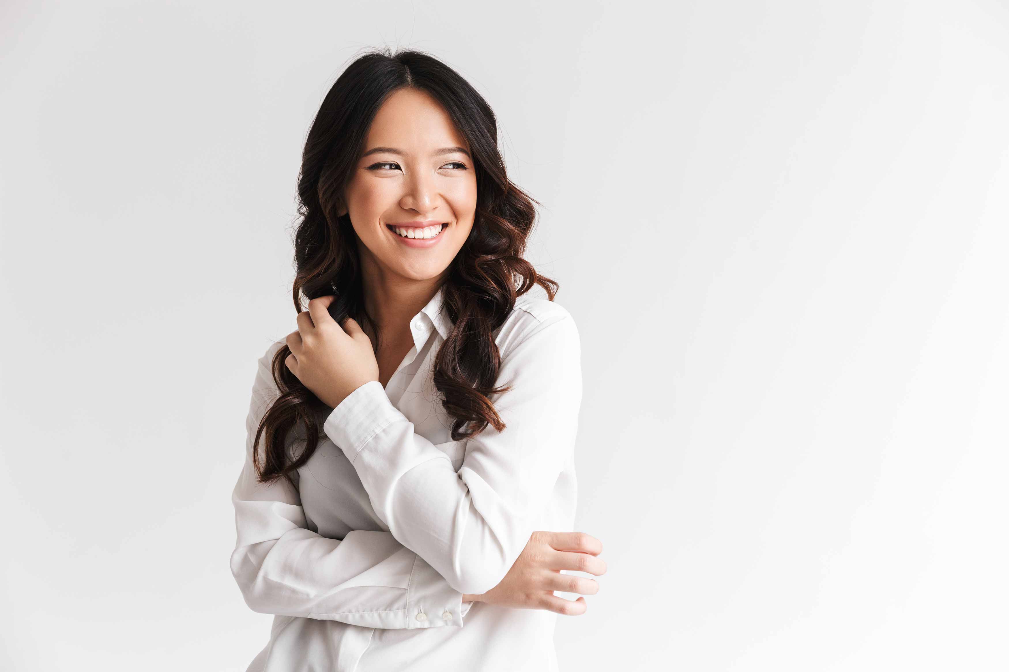 This photo shows an attractive female smiling broadly showing off her nice teeth