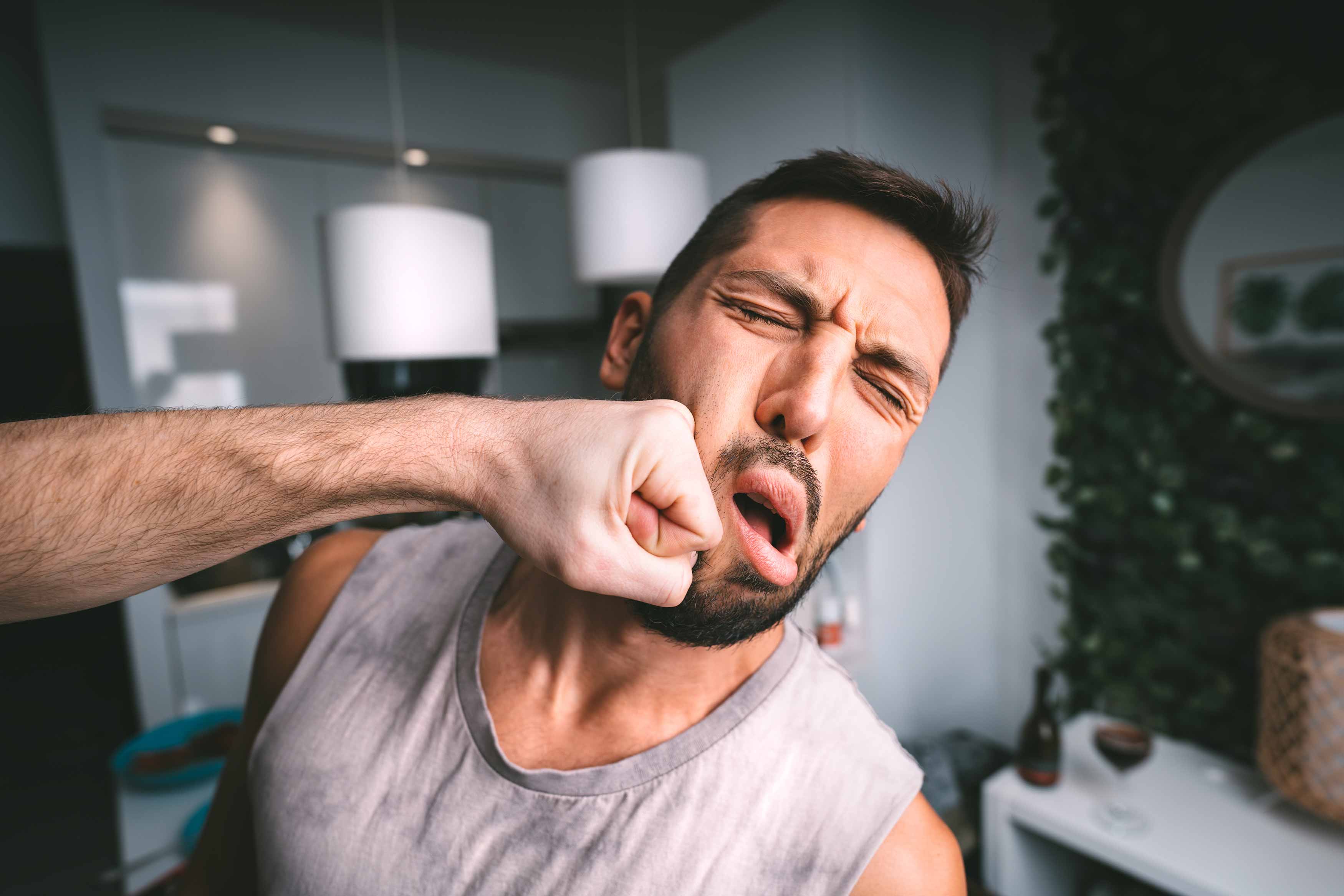 Photo of a man being punched in the jaw 