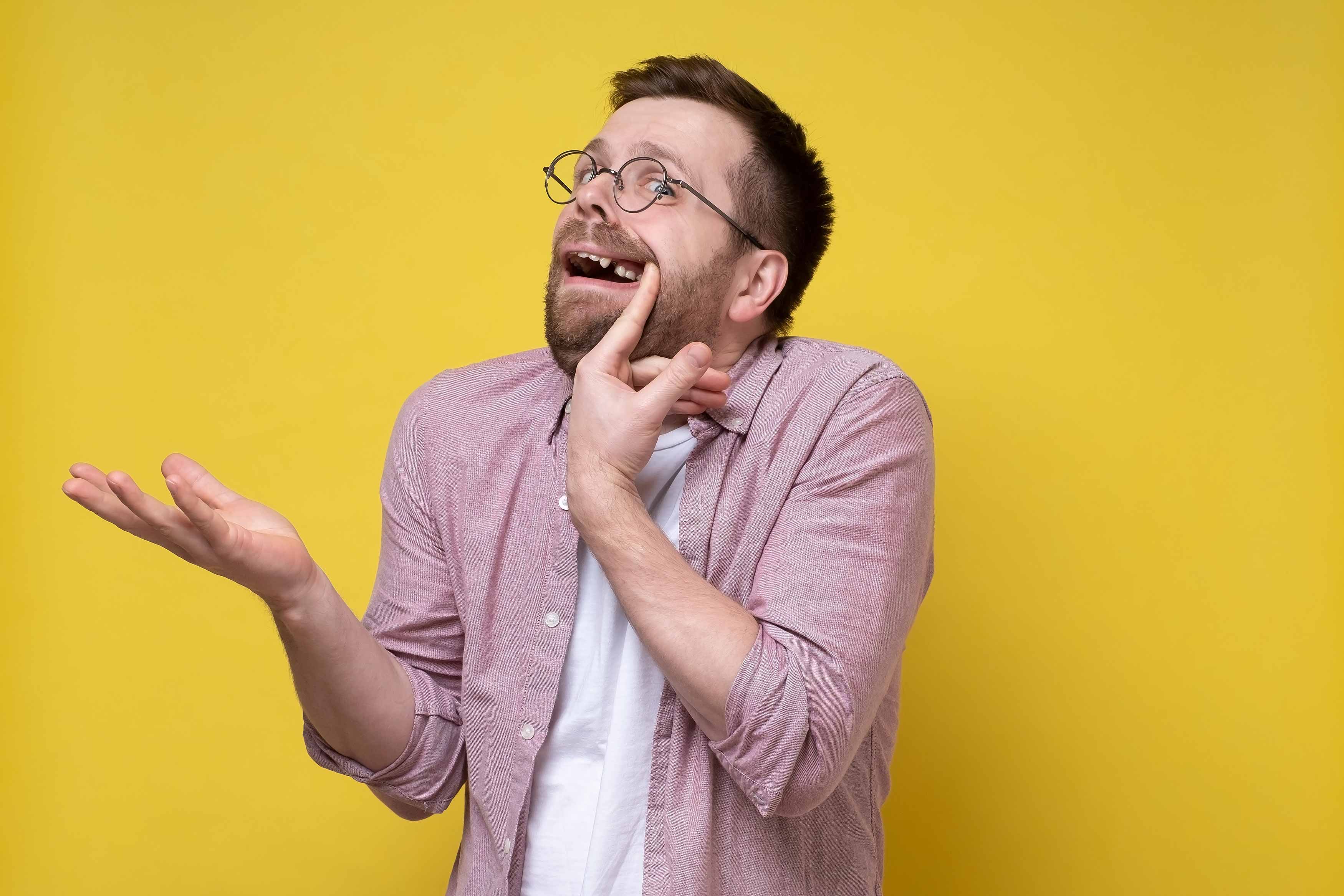 Photo of a man showing off his missing tooth 