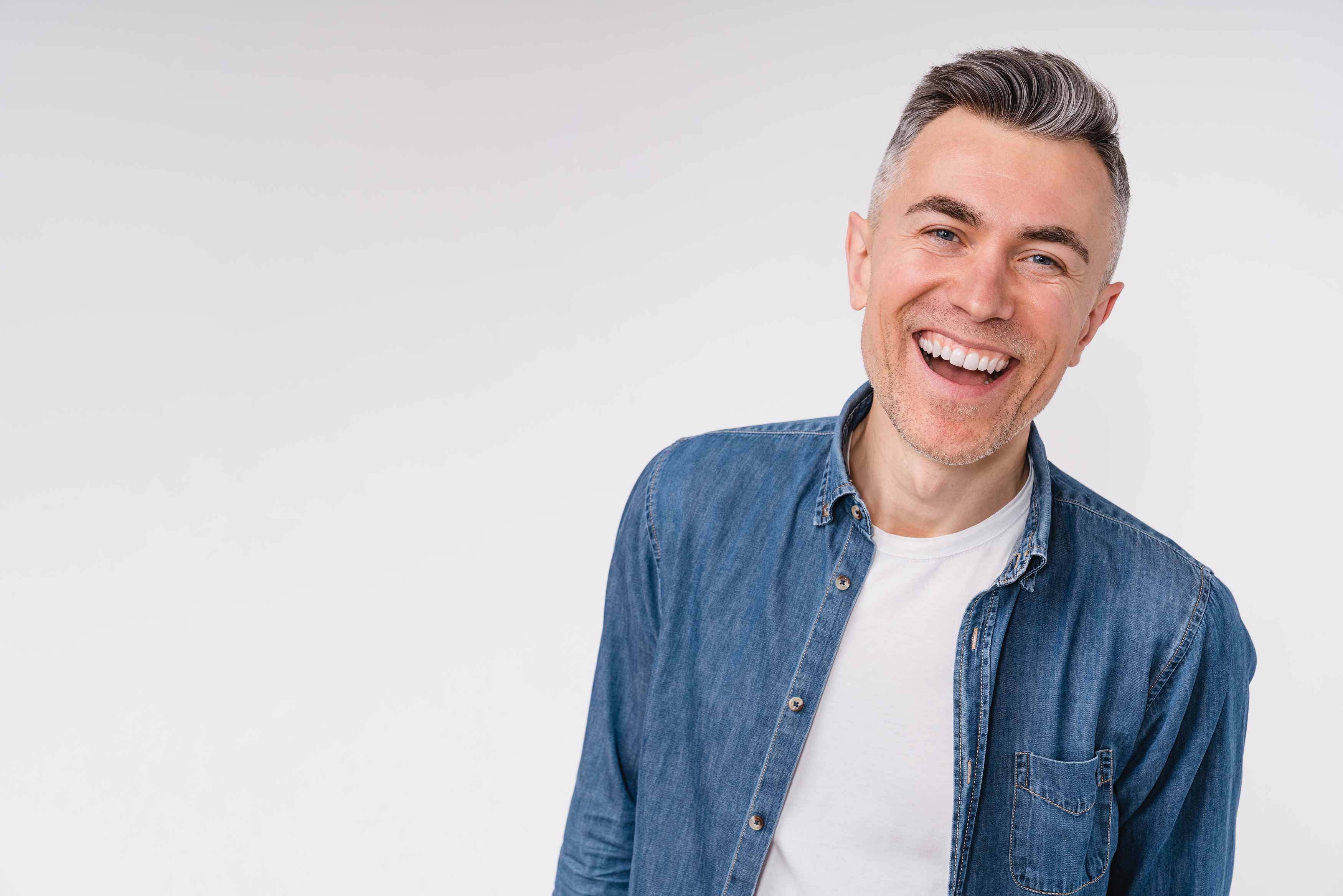 Photo of middle-aged man smiling confidentally 