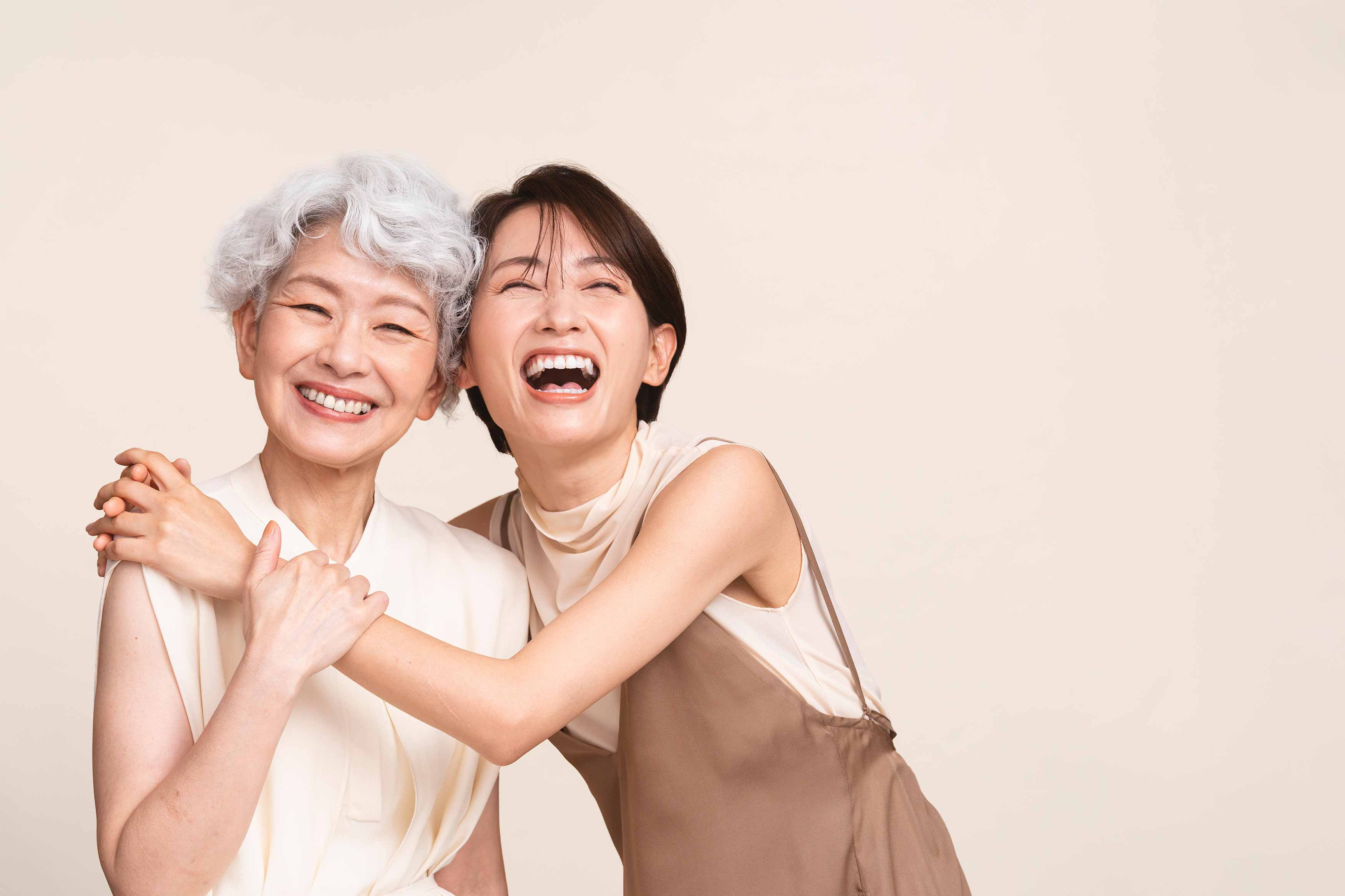 Photo of a young female hugging an older women