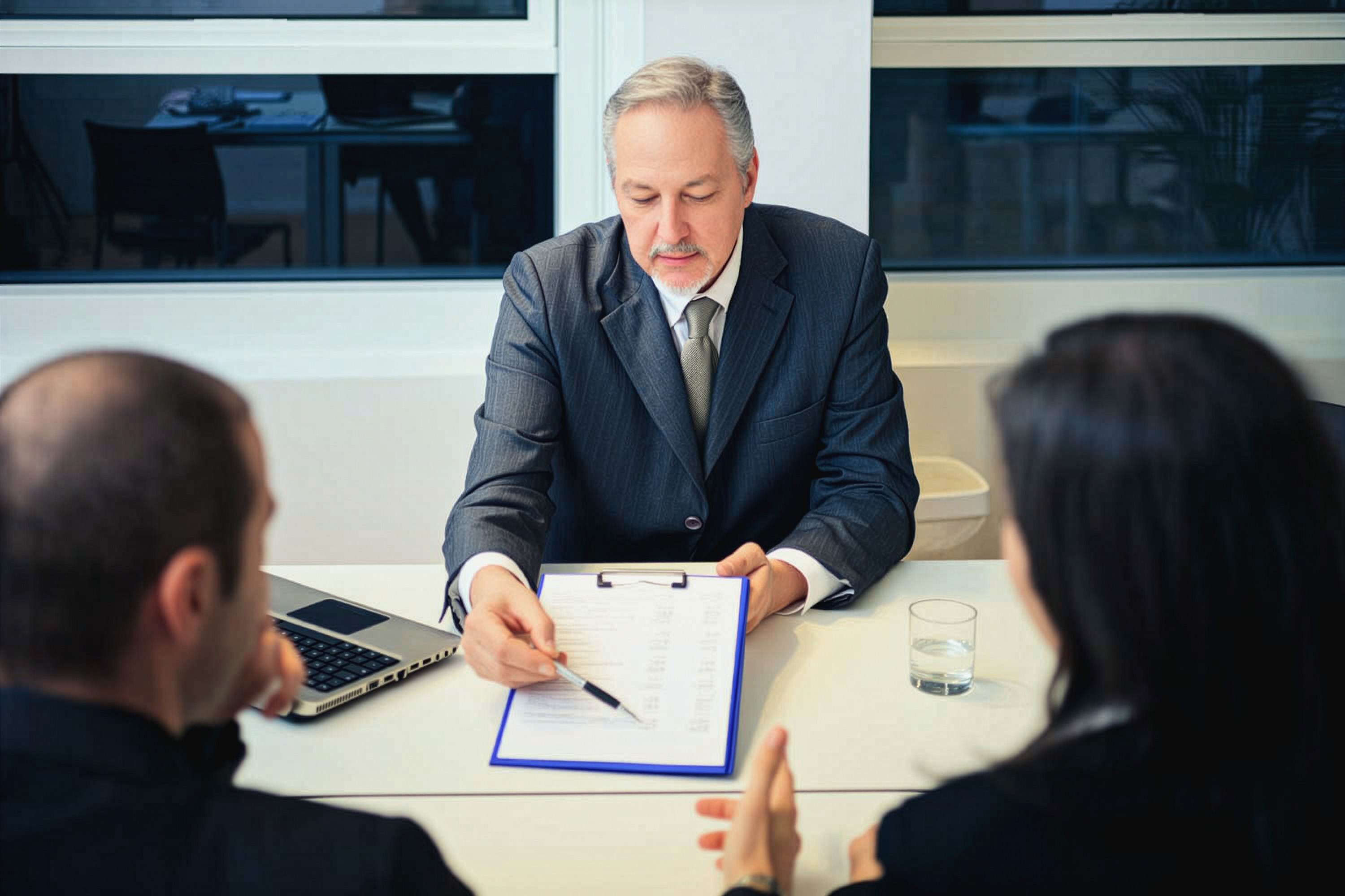 A banker showing documents to his clients