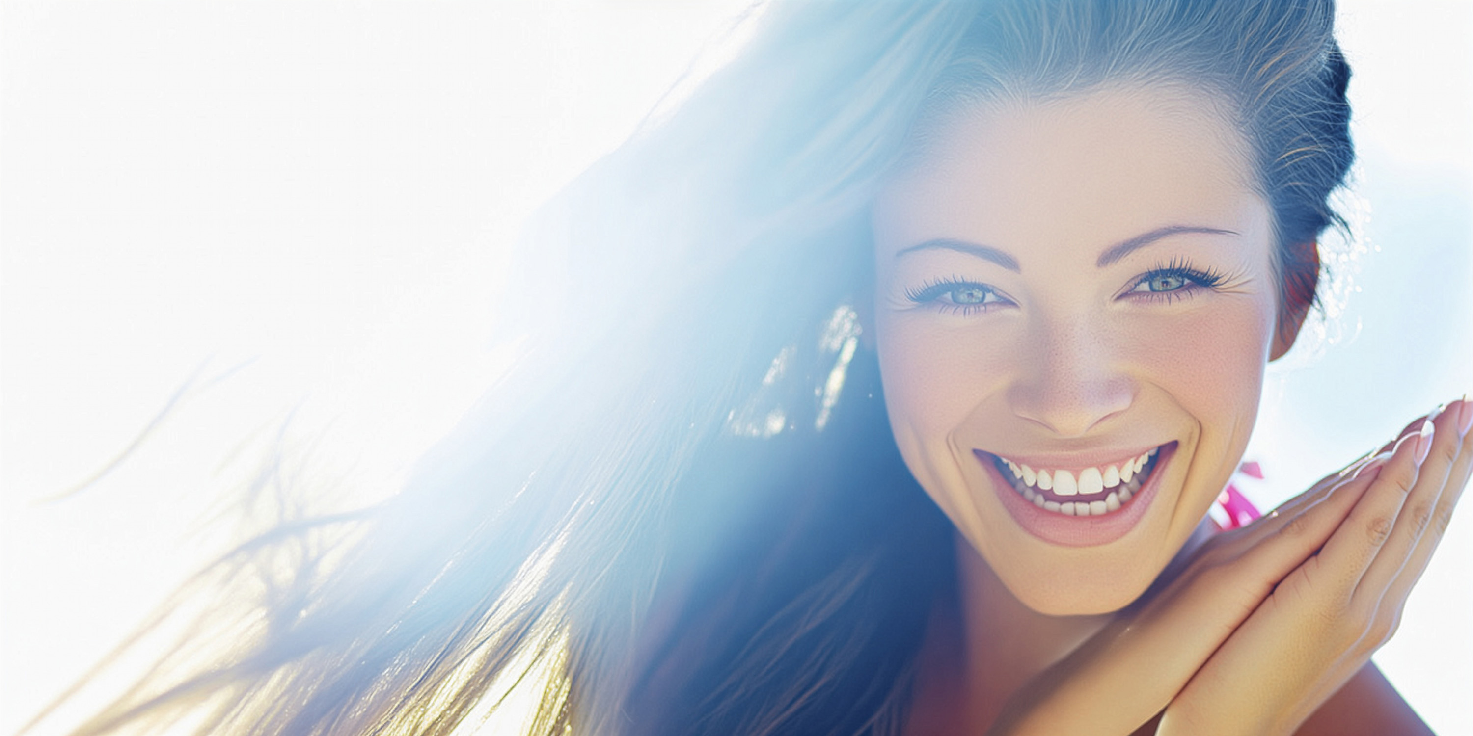 An attractive lady showing off her smile while the sun is glowing in the background. 