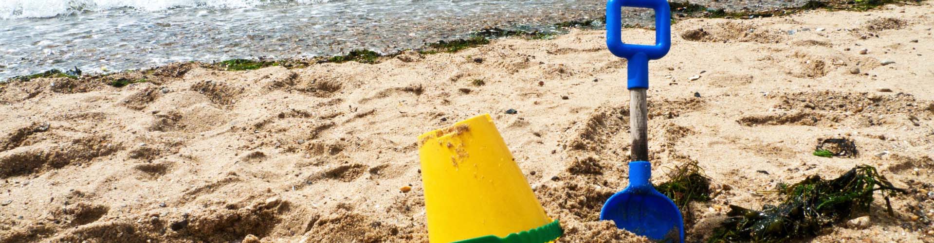 Bucket and spade in the sand on a sandy beach in Wales