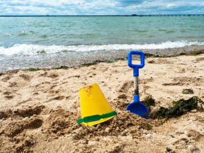 Bucket and spade in the sand on a sandy beach in Wales