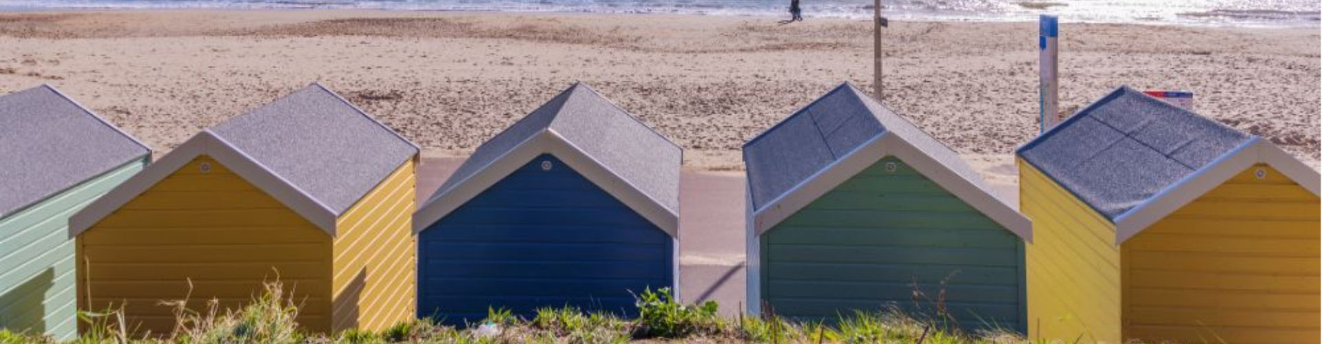 Colourful beach huts on a sandy beach