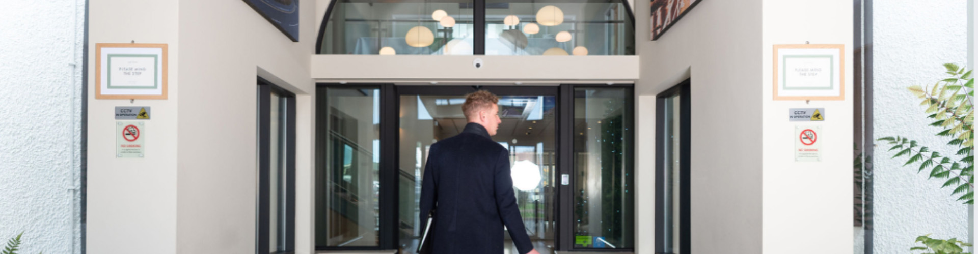 Man walking into the entrance of Park Lodge Hotel Aberystwyth