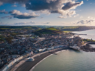 Aerial view of Aberystwyth seafront, promenade and town with Cardigan Bay coastline, Wales