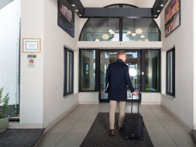 Man walking into the entrance of Park Lodge Hotel Aberystwyth