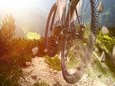 A mountain bike jumping over a rocky path
