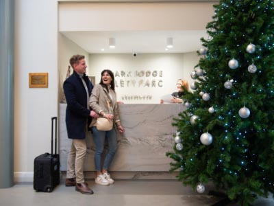 A couple checking in at Park Lodge Hotel reception