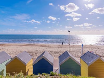 Colourful beach huts on a sandy beach