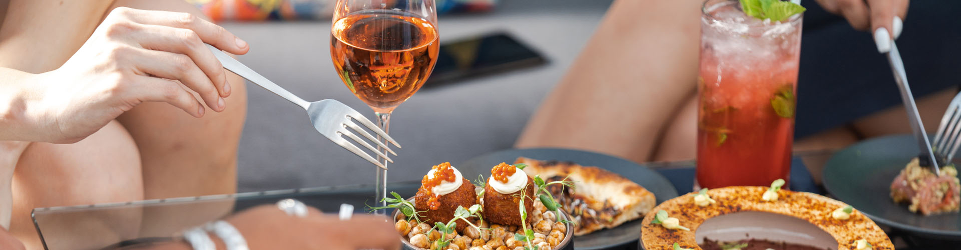 Diners sharing food at a restaurant table – places to eat in Aberystwyth