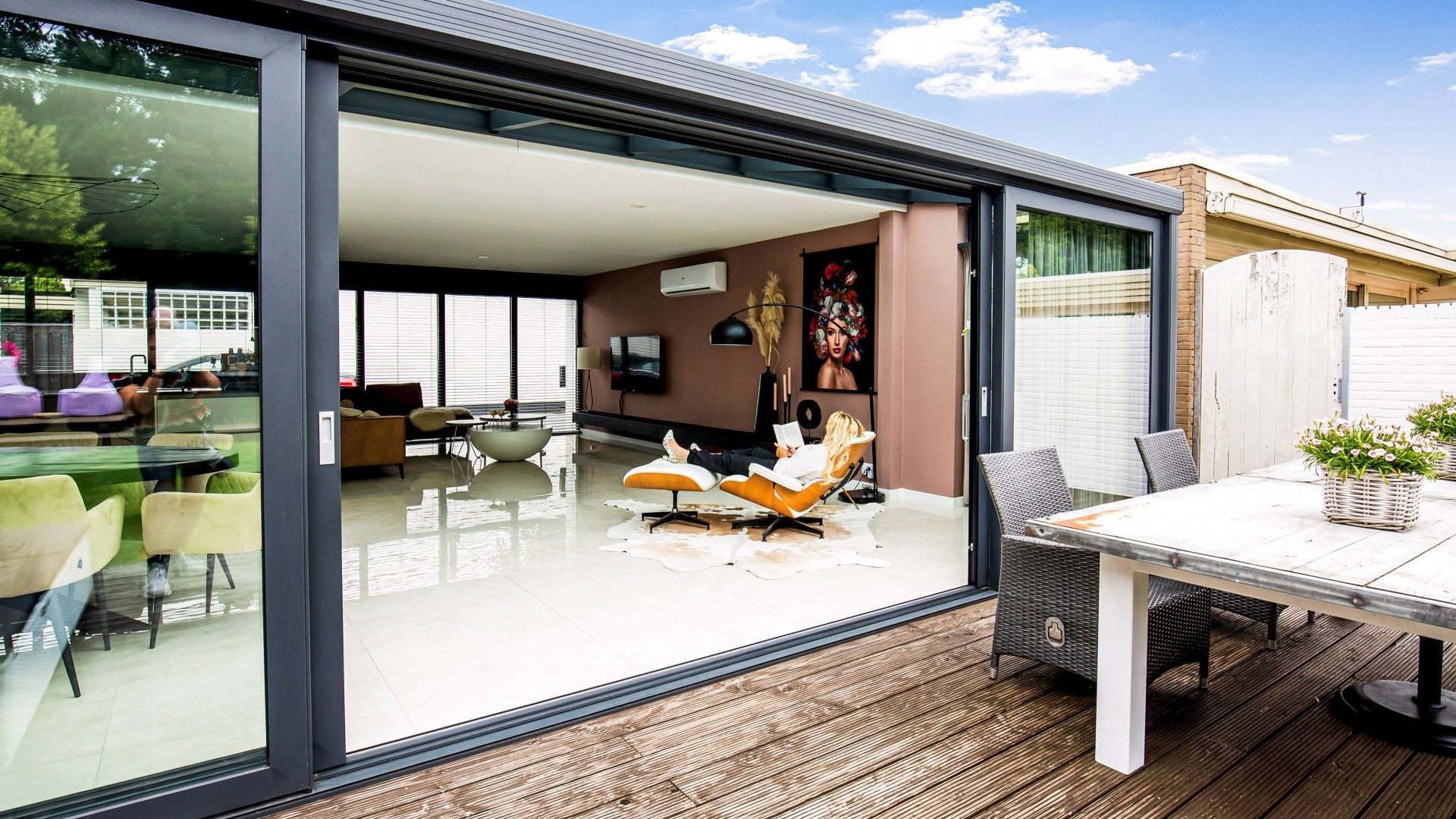 Buitenaanzicht serre met open schuifwand en terras