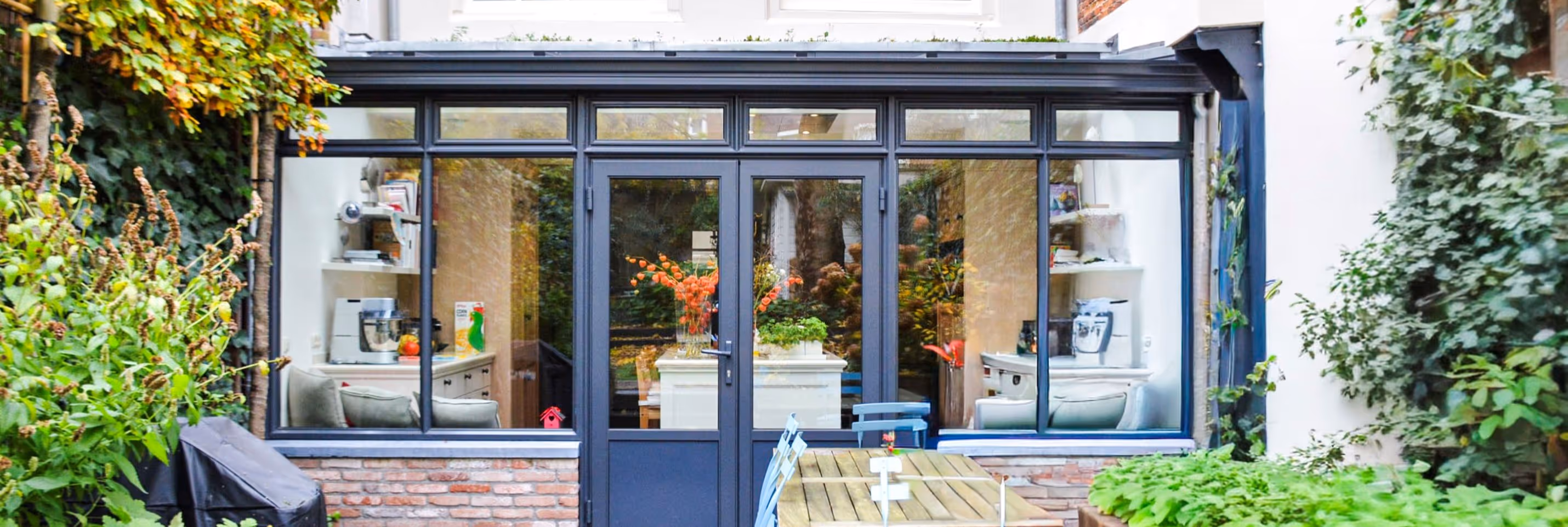 Steellook serre Amsterdam - Luxe glazen uitbouw aan klassieke woning met moderne stalen pui