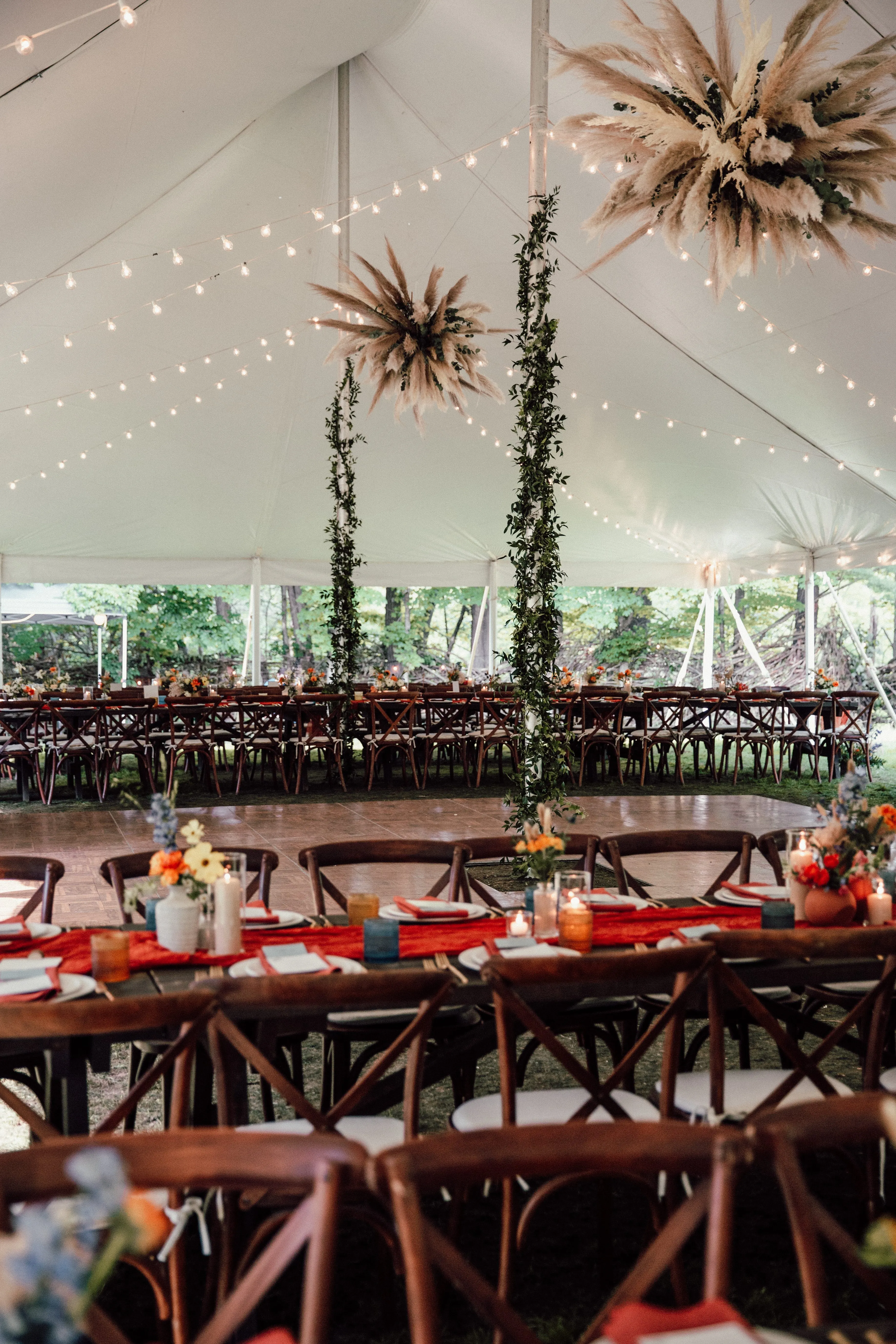 Tented reception with hanging pampas grass and greenery installations over the dance floor at Glen Falls House