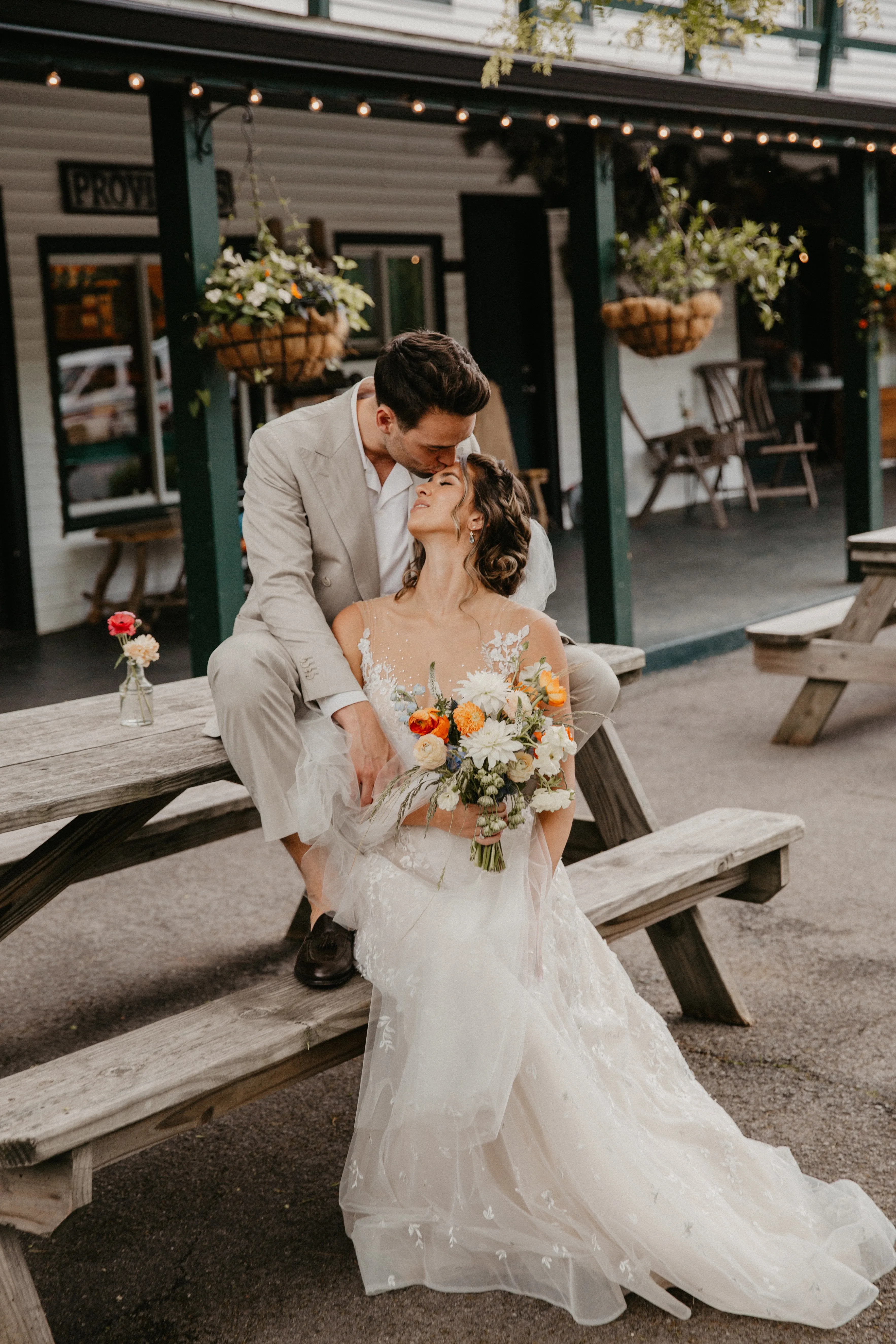 Portrait of the bride and groom with a colorful wildflower bouquet at Glen Falls House