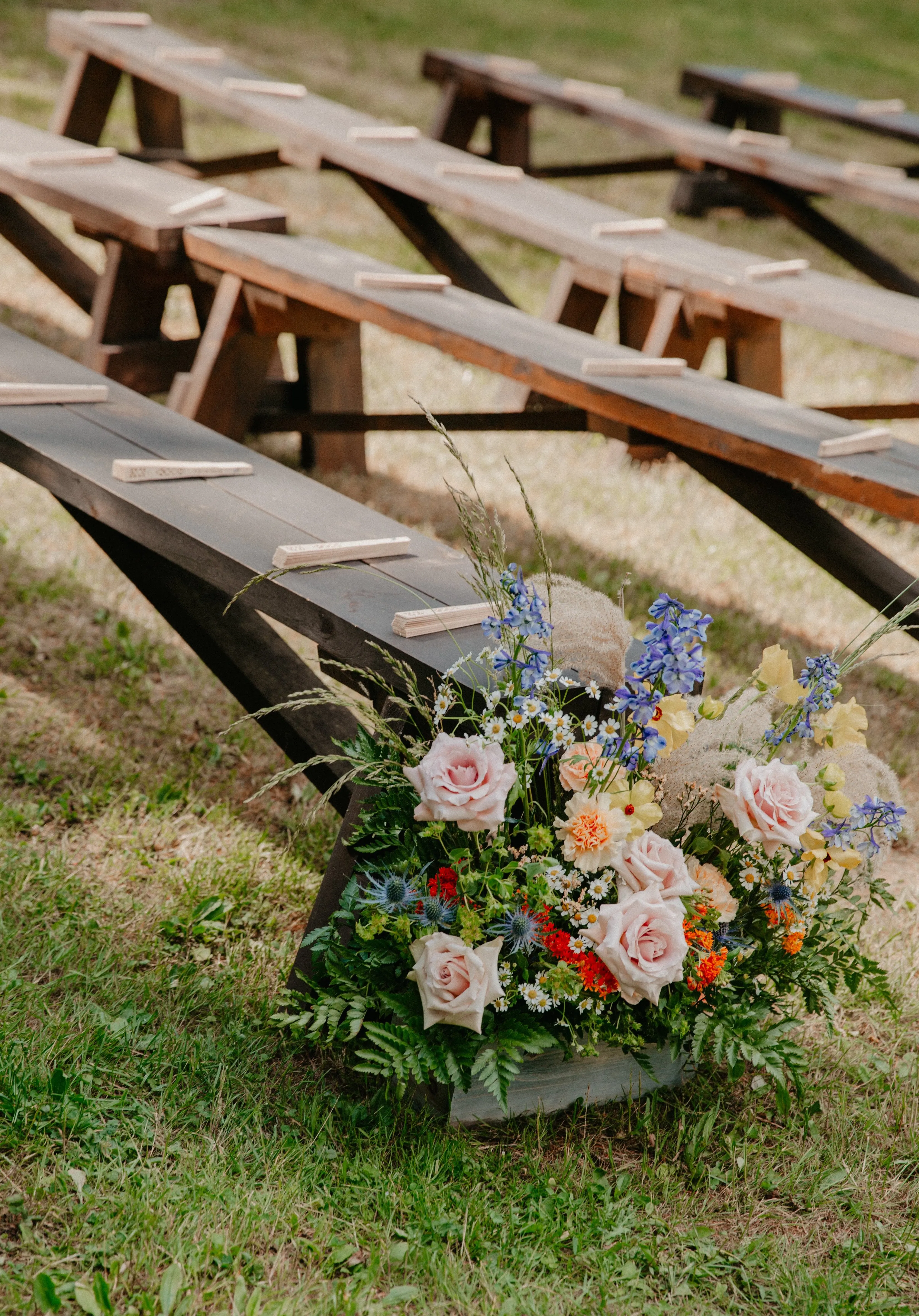 Wildflower aisle arrangements lining the ceremony at Glen Falls House