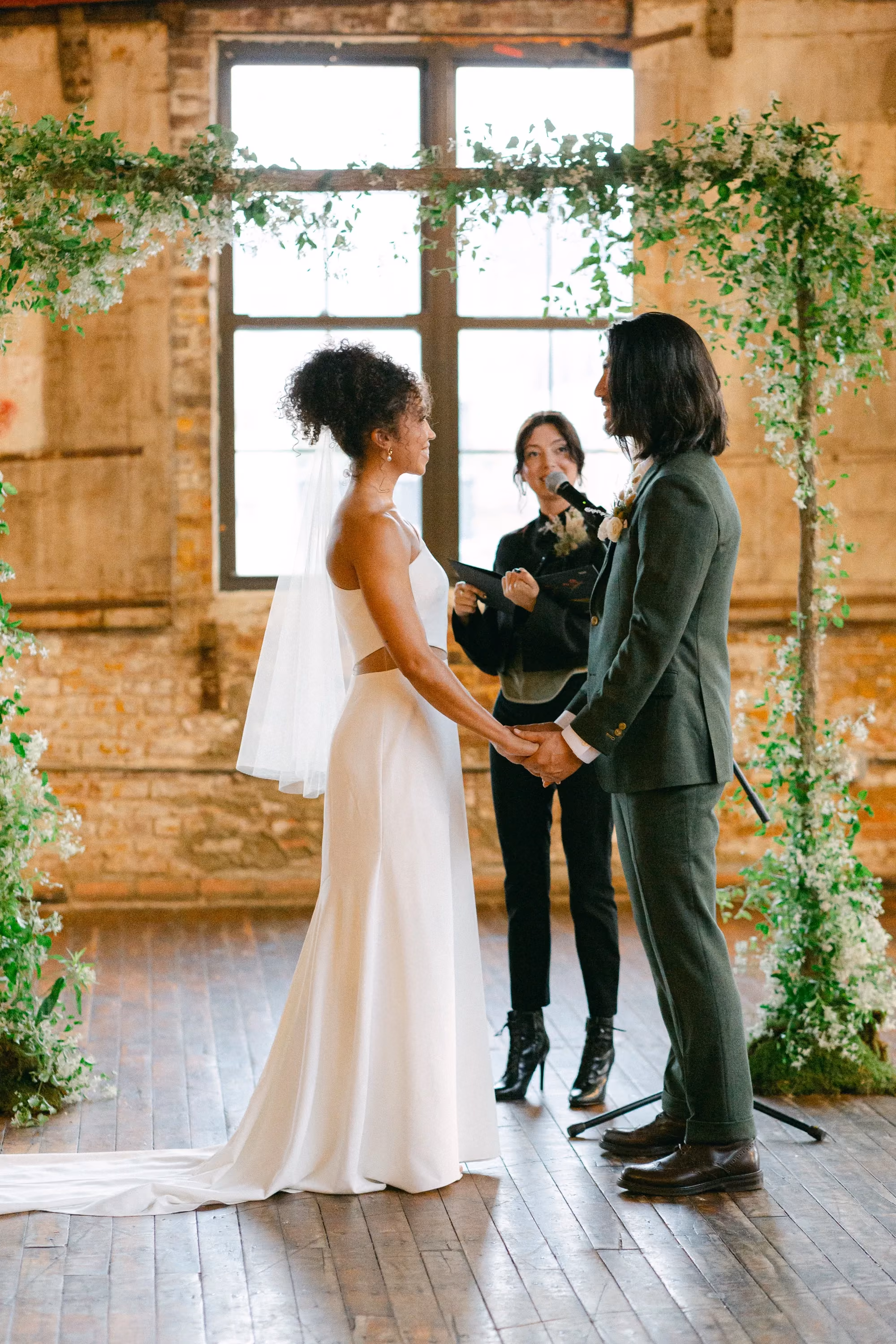 Greenpoint Loft Wedding Ceremony, floral arch with bride and groom
