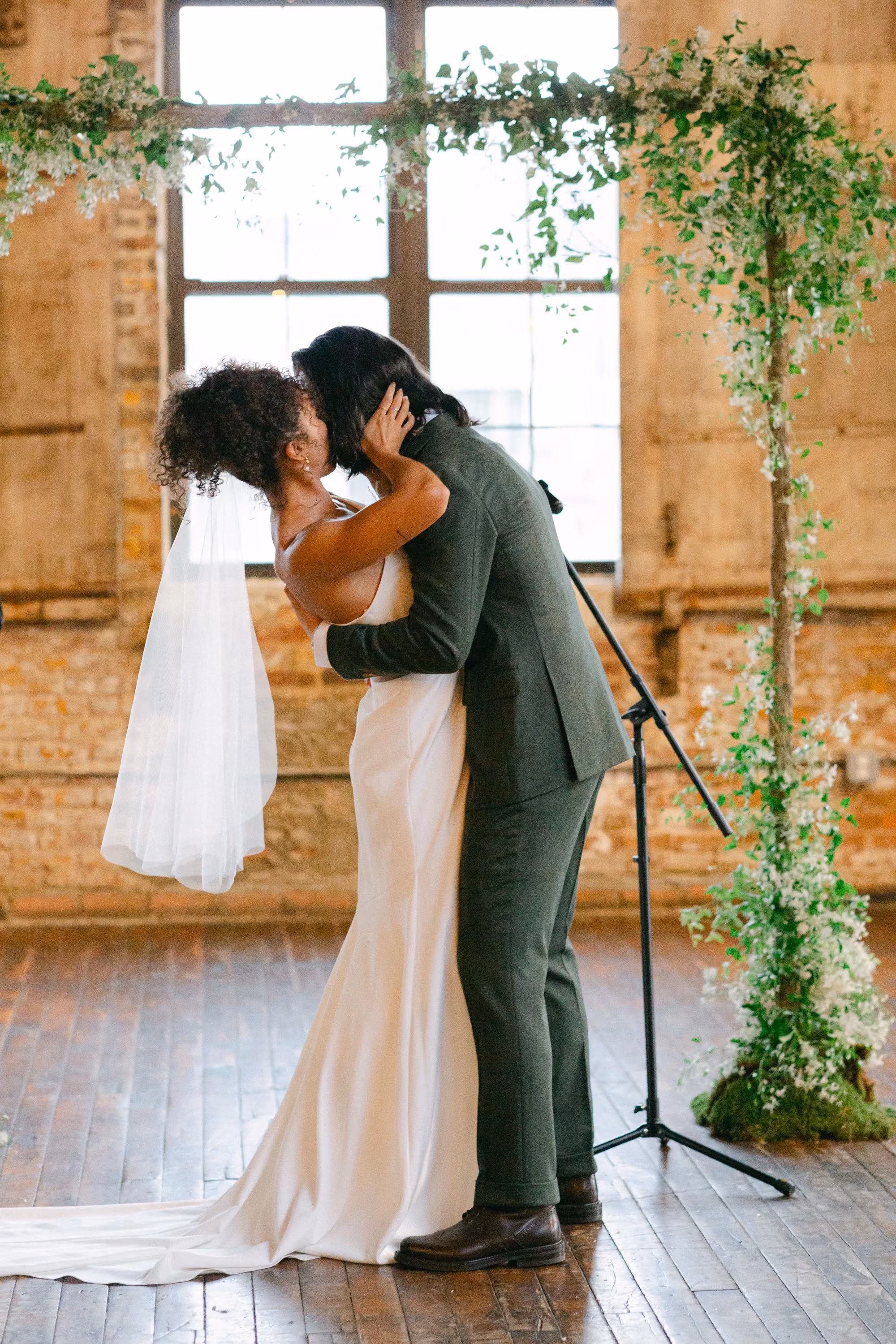 Greenpoint Loft Wedding Ceremony, floral arch with bride and groom