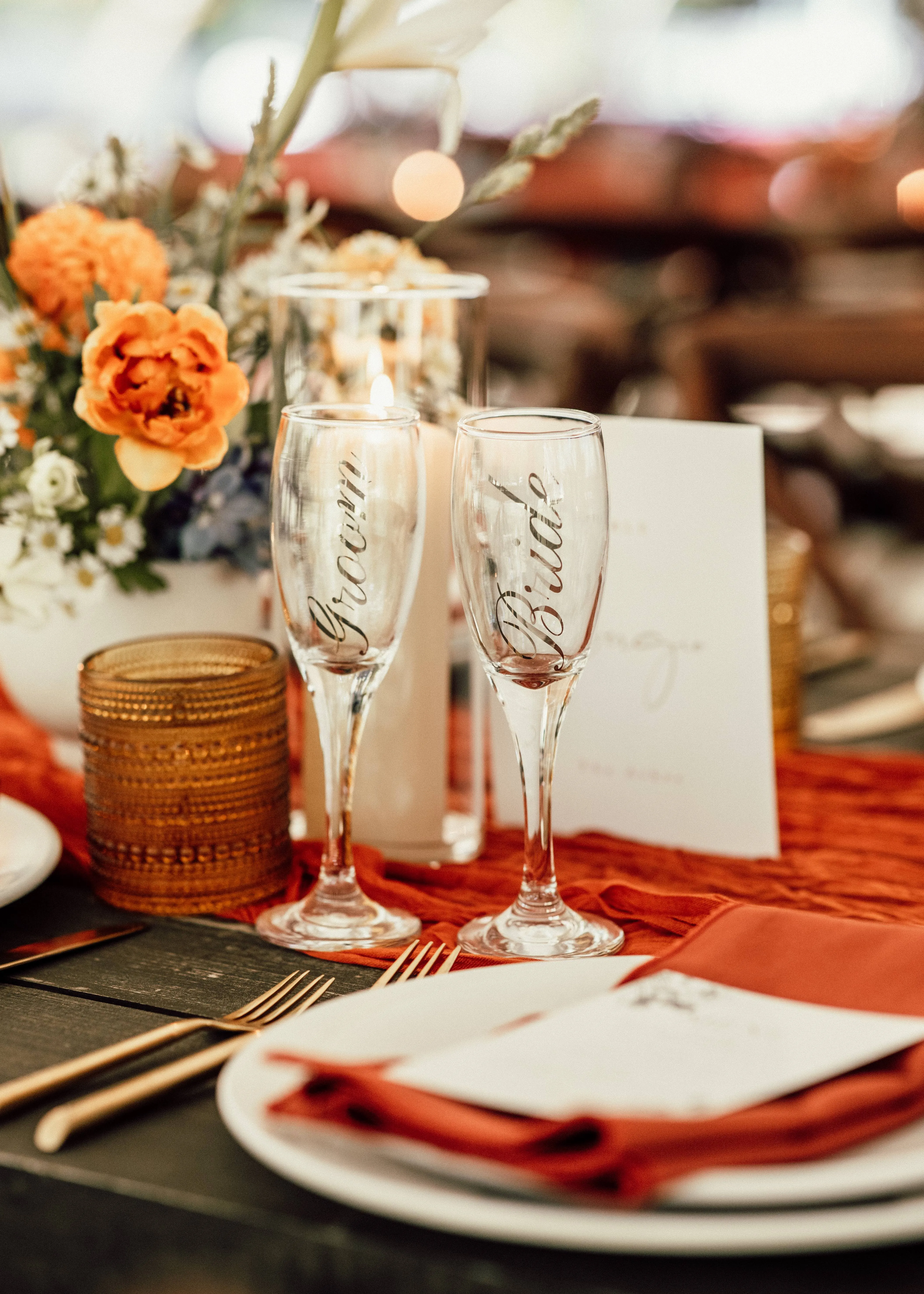 Wedding guests raising a toast beside a floral reception centerpiece at Glen Falls House