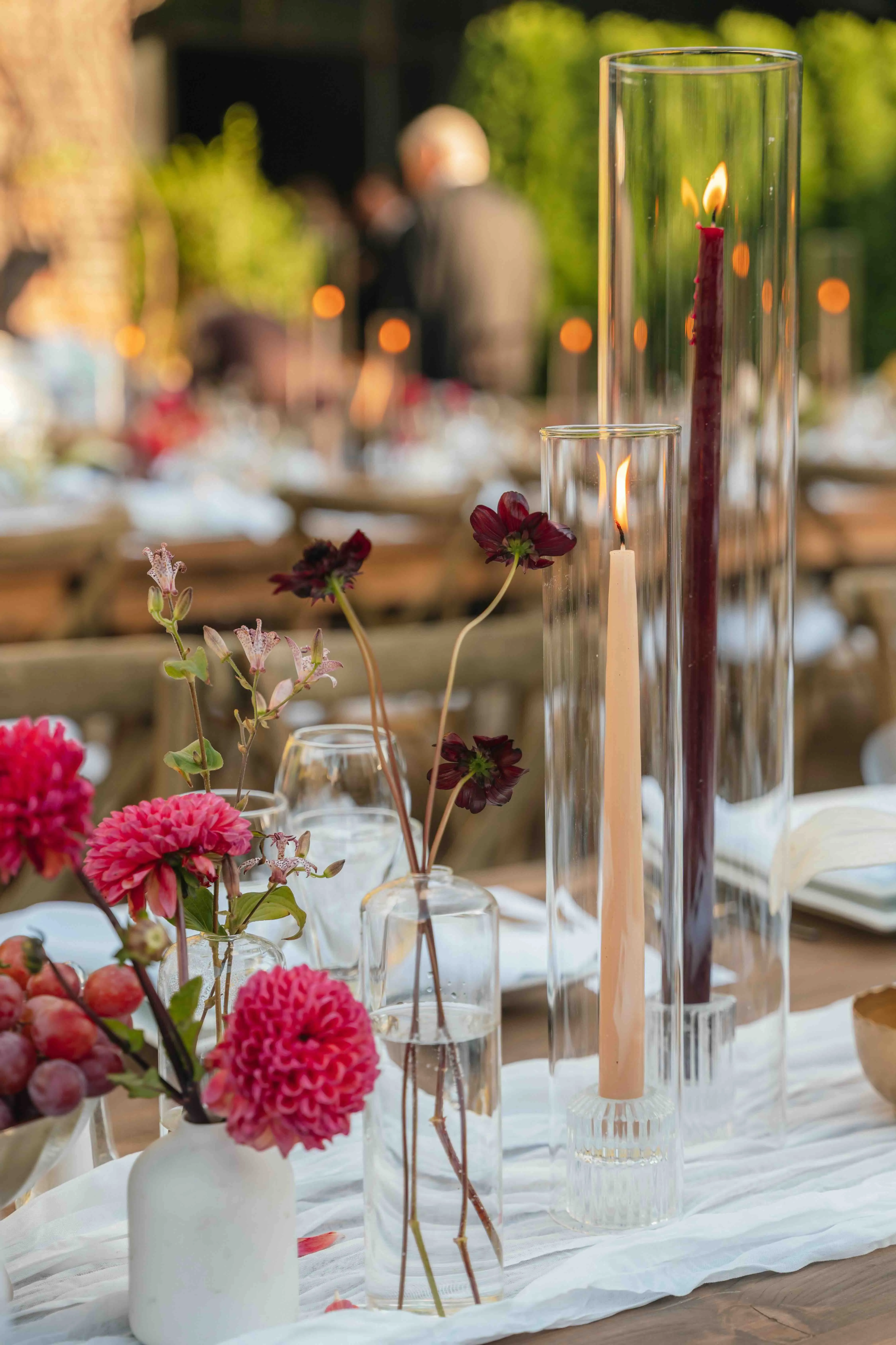 Reception table detail with pink dahlias, chocolate cosmos, and fresh grapes