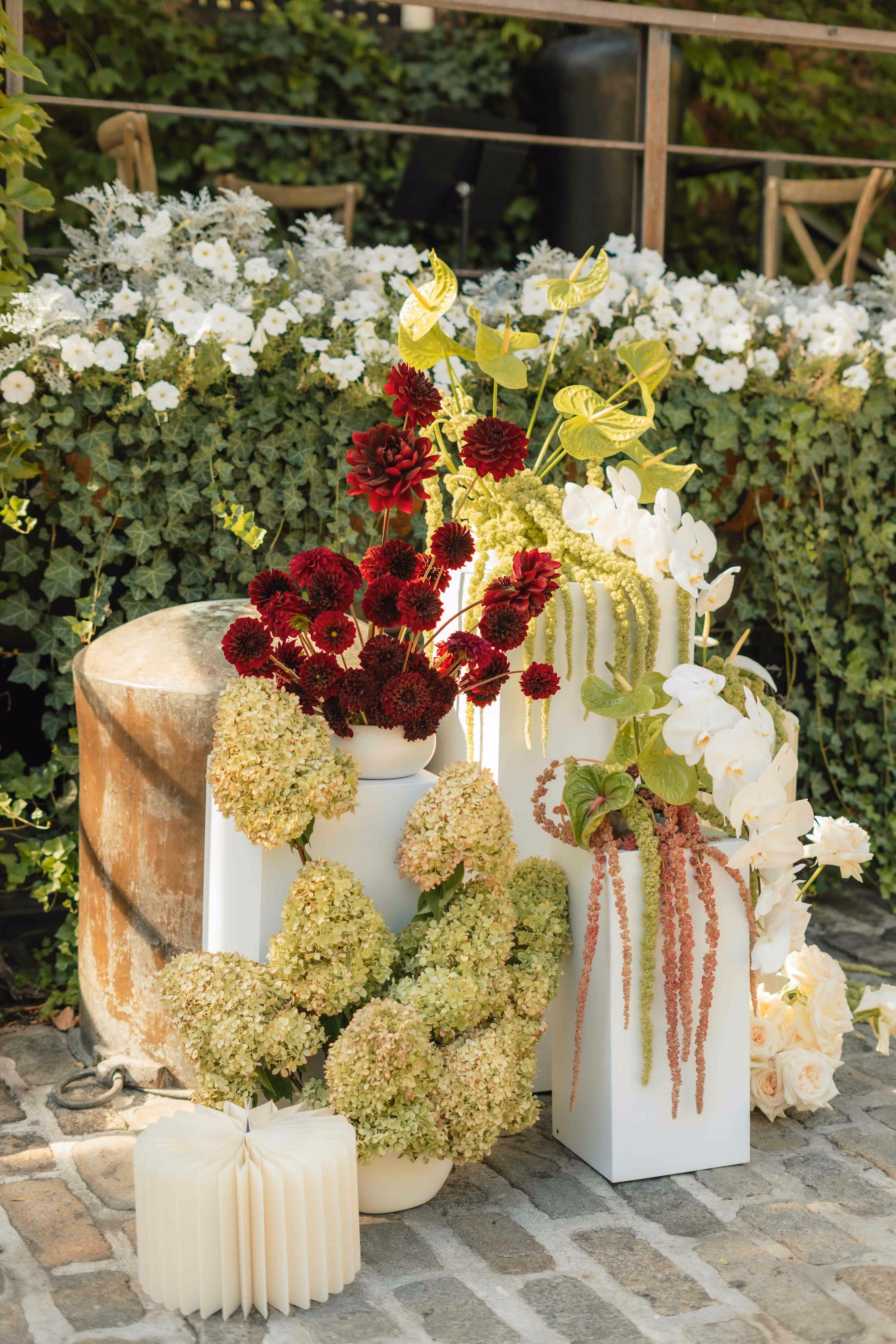 Pedestal flowers in white, green and burgundy