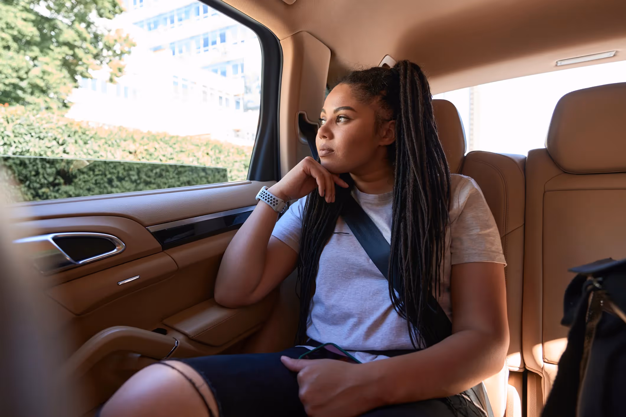 A woman sitting in a car on the way to her Lyft sexual assault lawyer's office.