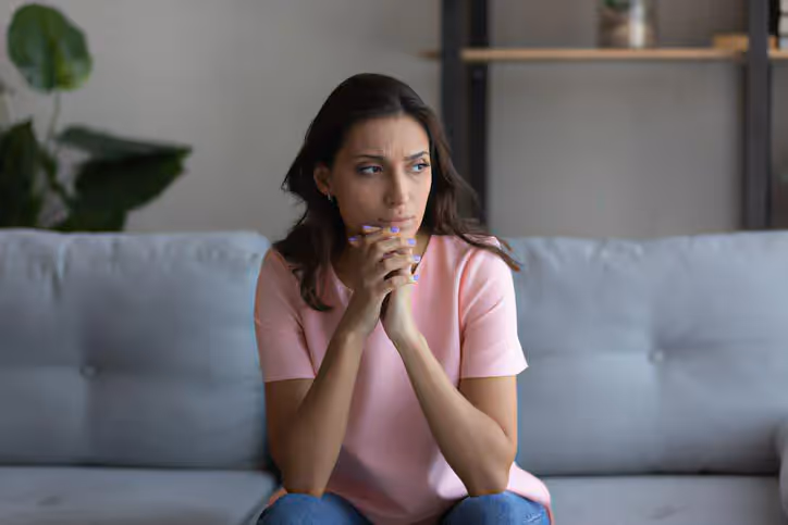 A woman sitting on the couch waiting for her San Francisco sexual assault lawyer to call her.