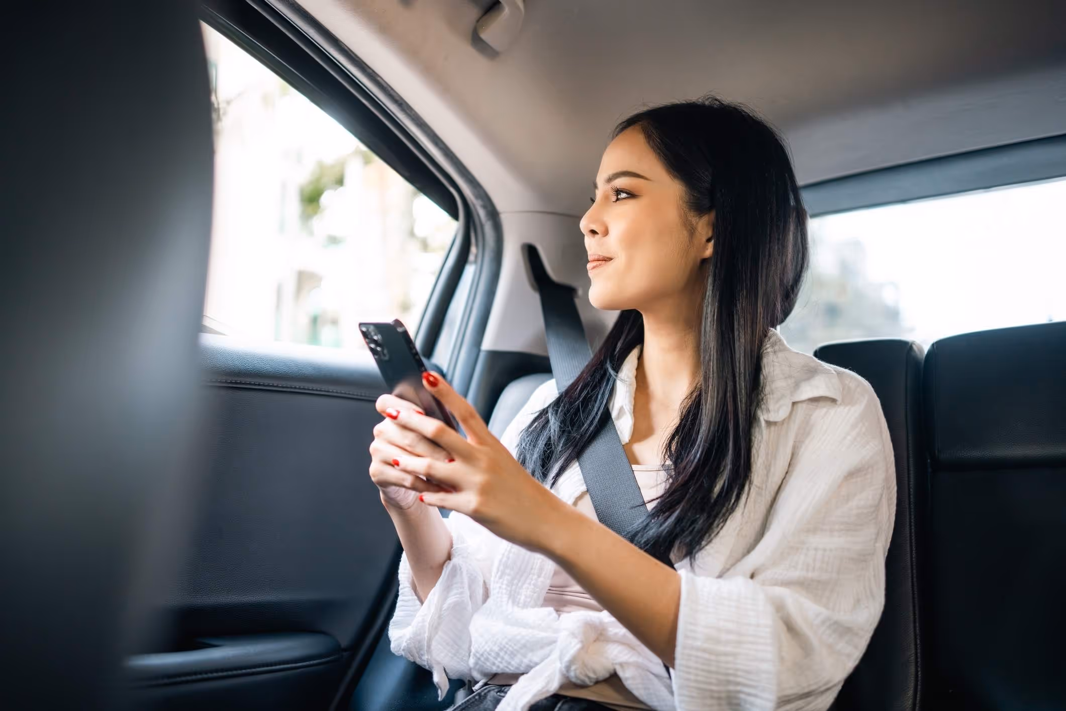 A woman in an Uber, highlighting the need for an Atlanta Uber sexual assault lawyer to protect victims’ rights.