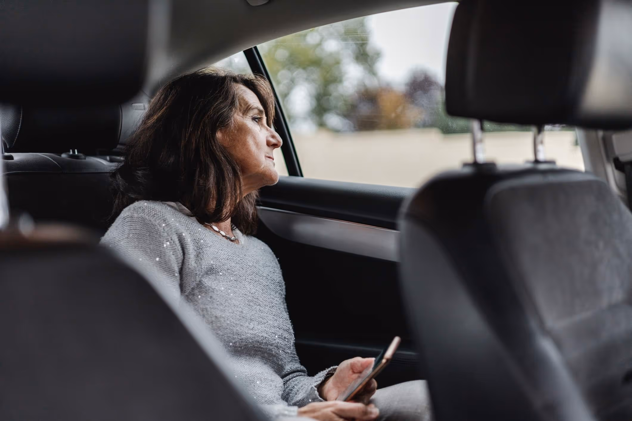 A passenger in an Uber, illustrating the importance of a Fort Lauderdale Uber sexual assault lawyer for support.