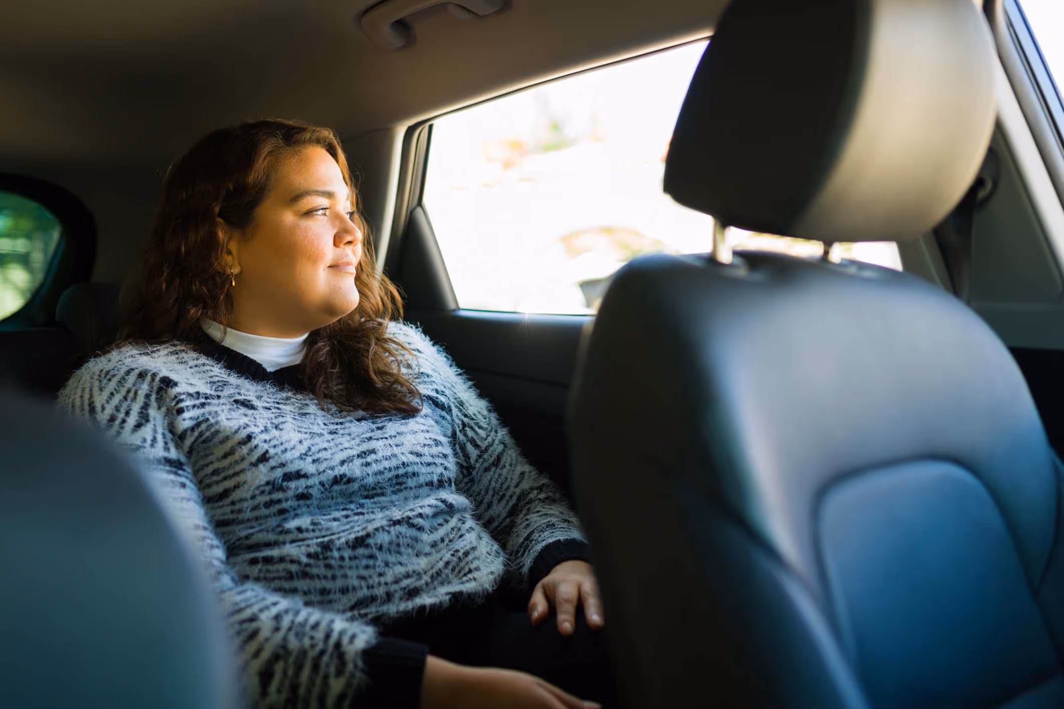 Woman riding in a rideshare car, representing support from a Washington Uber sexual assault attorney.