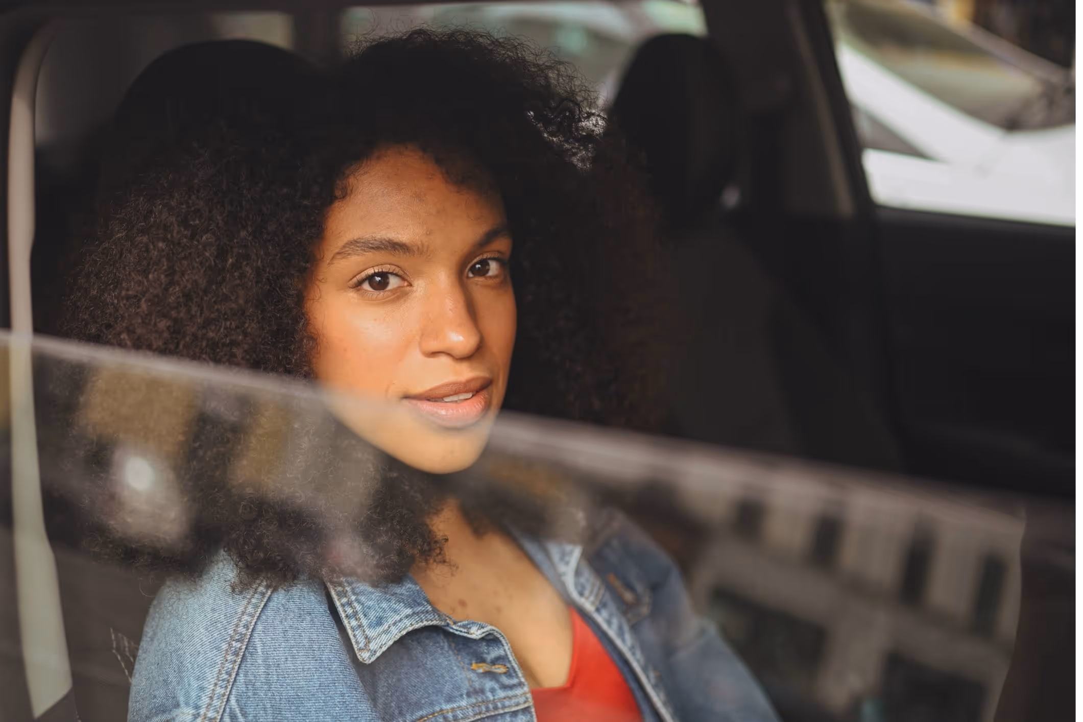 Young woman in car, symbolizing help from a New York Uber sexual assault attorney.