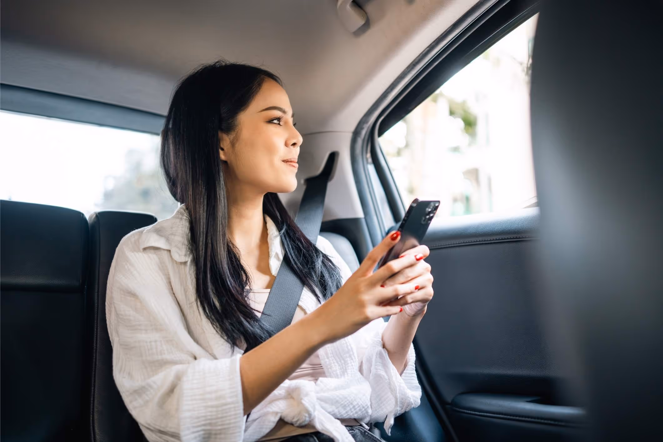 A woman in an Uber, highlighting the need for an Atlanta Uber sexual assault lawyer to protect victims’ rights.