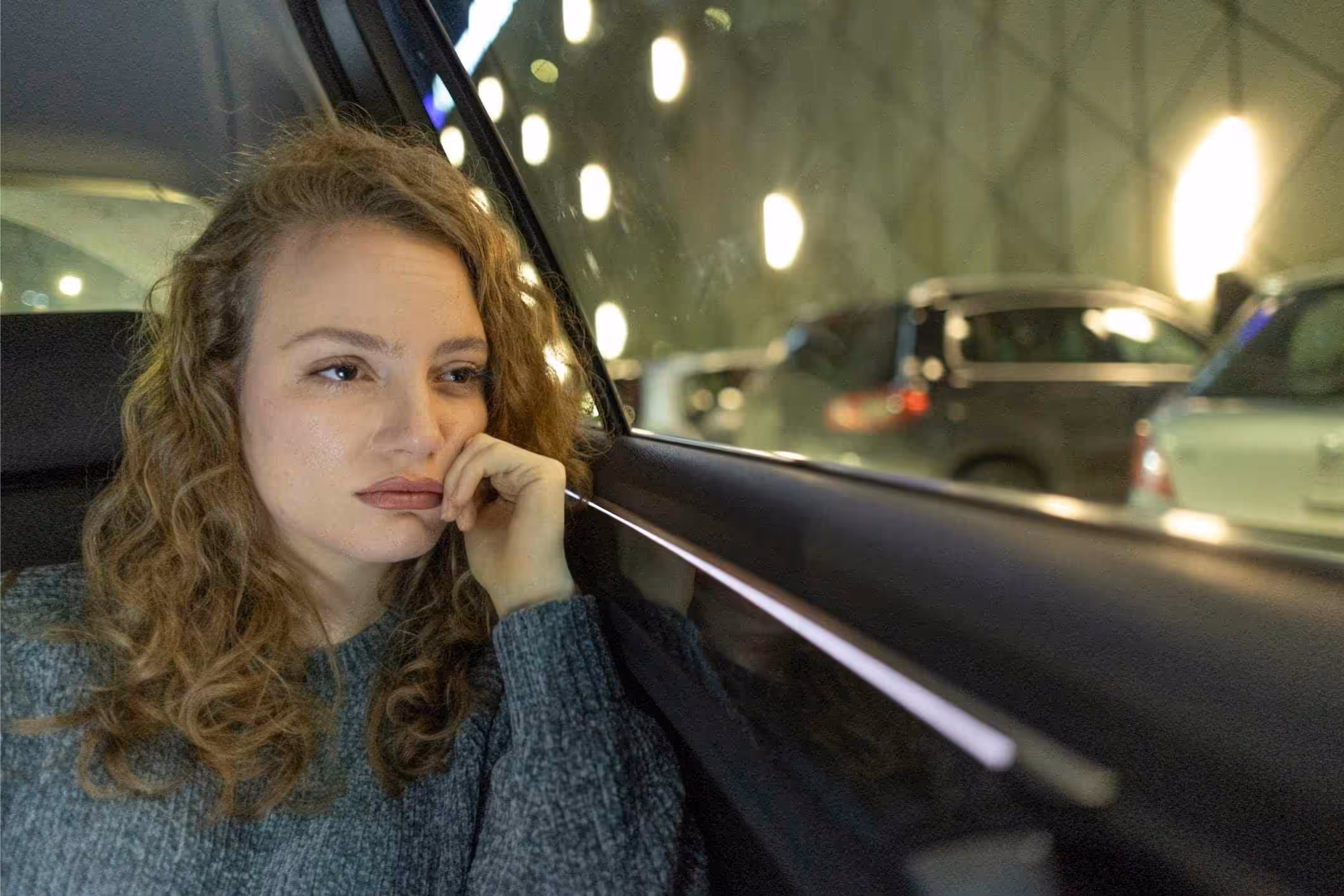 A survivor riding in a car considers contacting an Alabama Uber sexual assault lawyer.