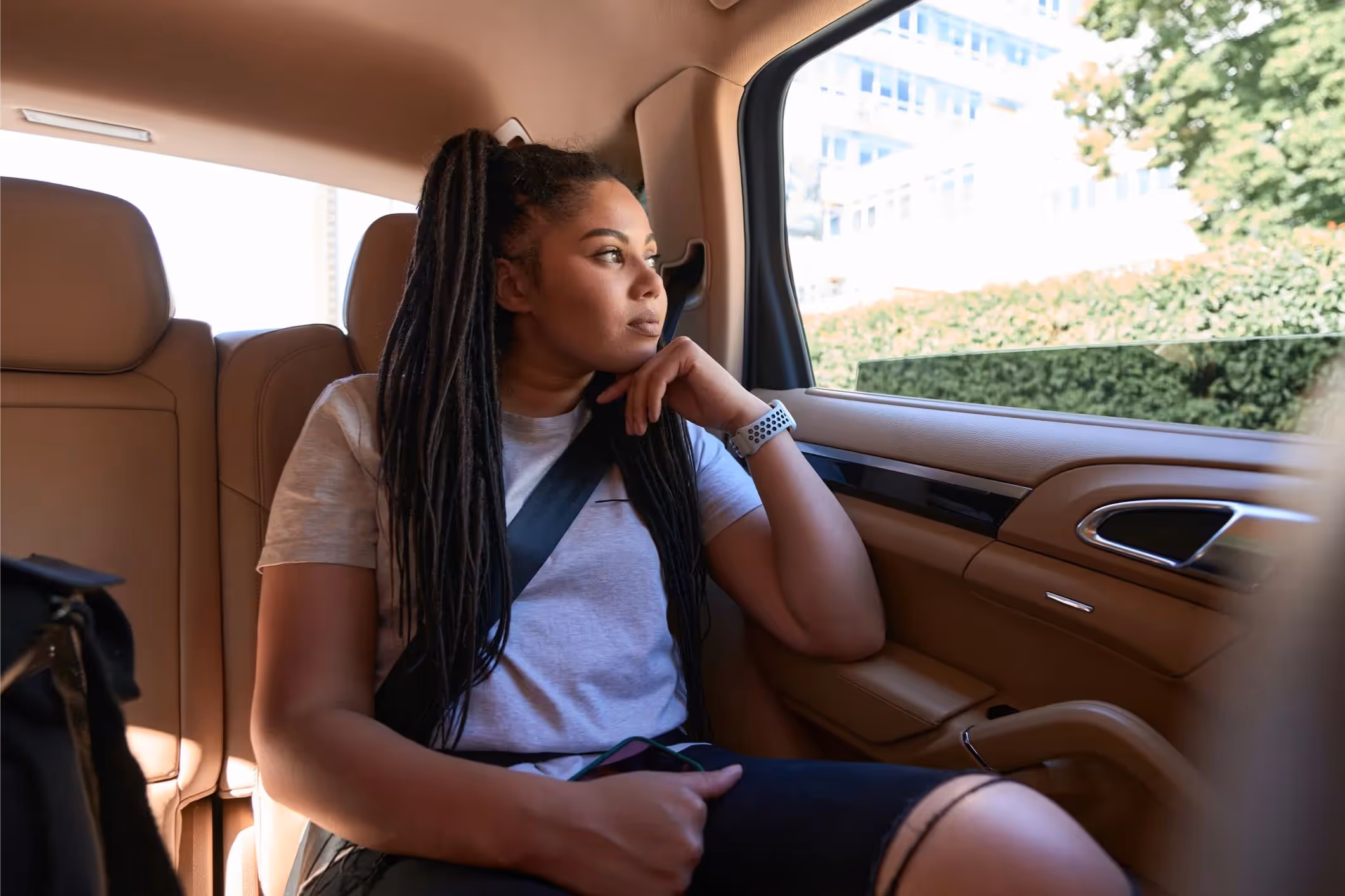 A woman sitting in a car on the way to her Lyft sexual assault lawyer's office.