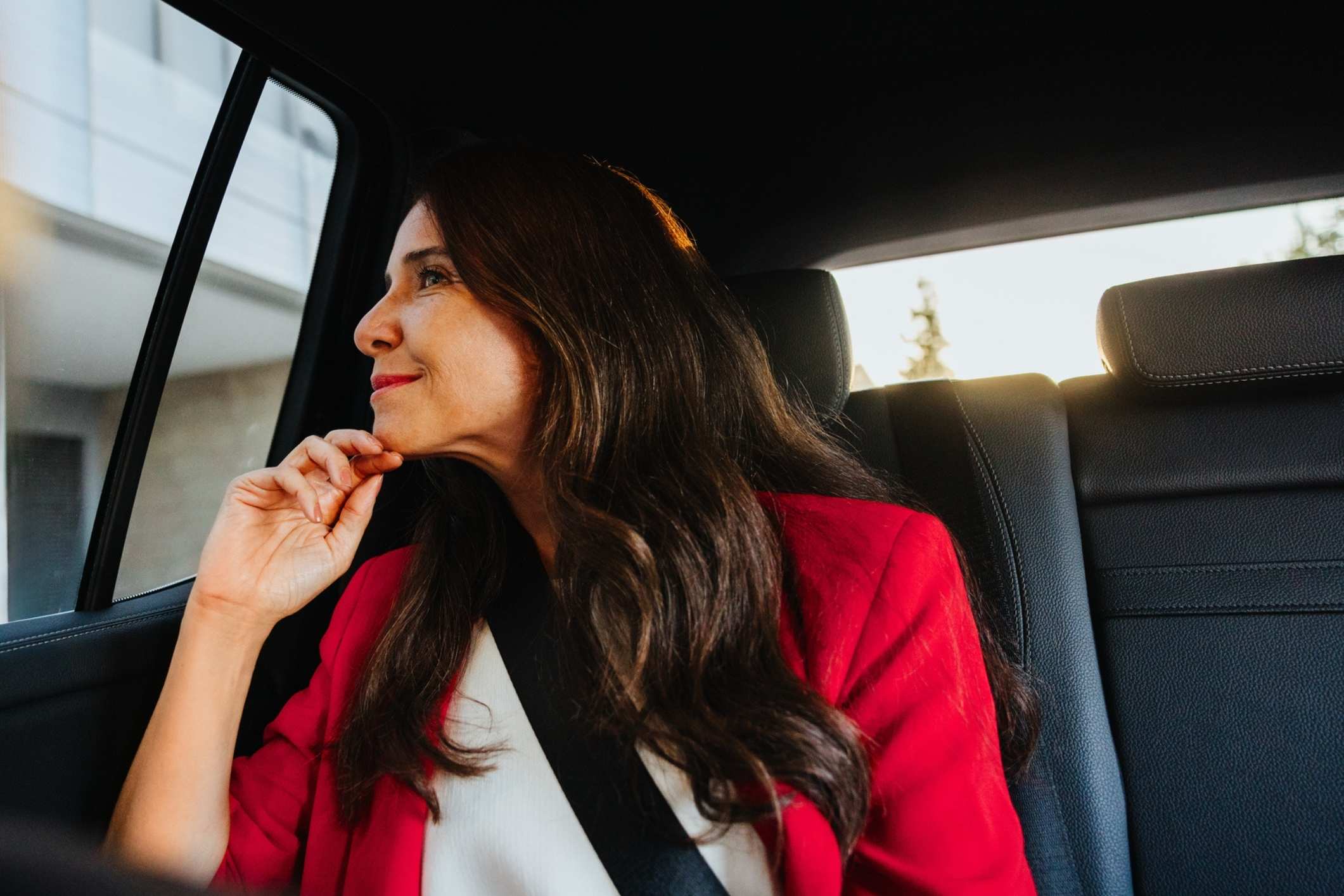 Woman in business attire in a car, representing survivors seeking a Miami Uber sexual assault attorney.