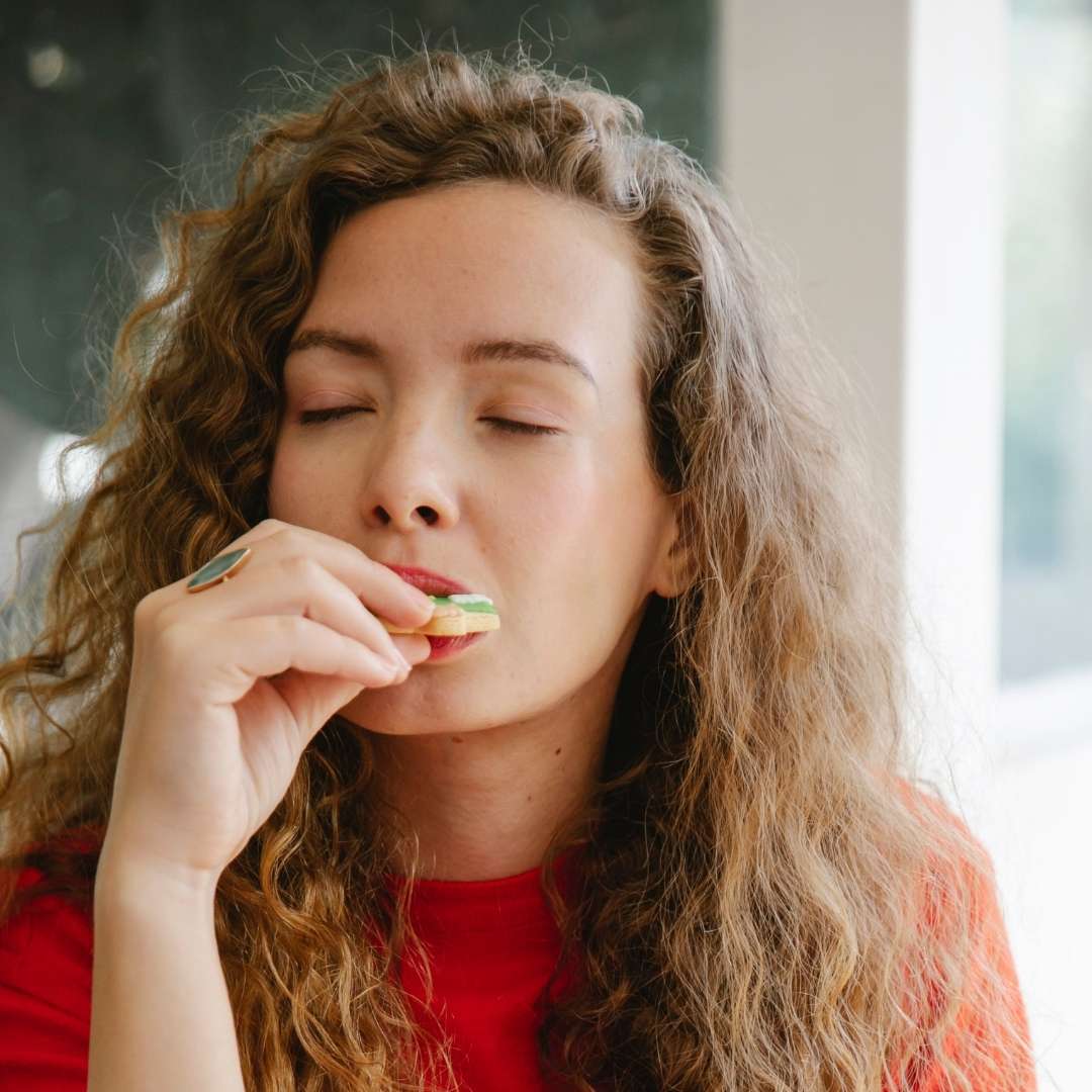 Happy girl eating a French pastry