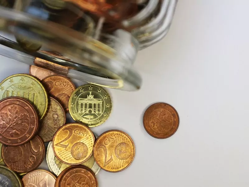 A jar with various Euro coins.