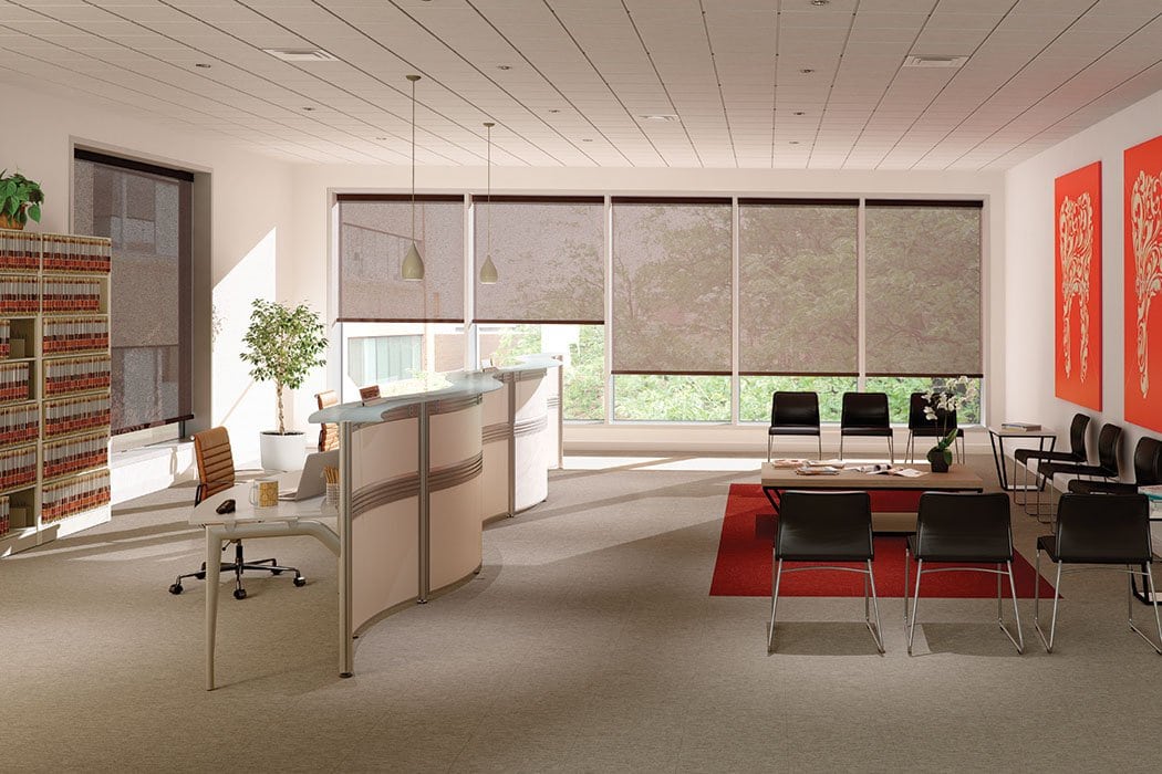 Modern office with window shades and minimal decor.