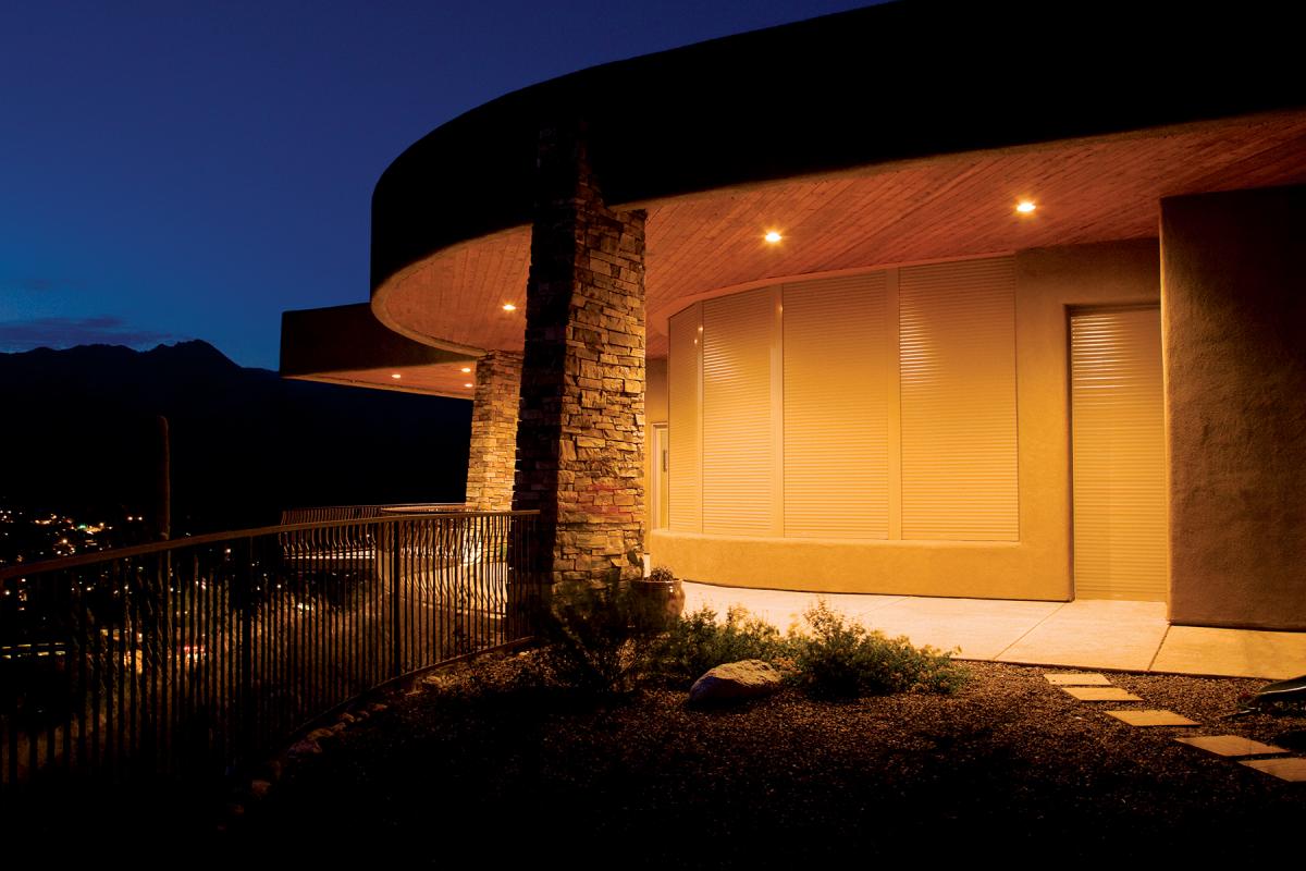 Modern home with closed blinds at night.
