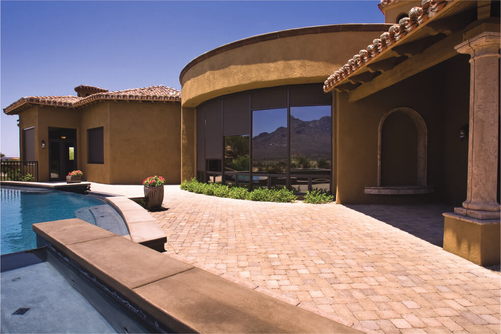 Modern home with large windows and pool.