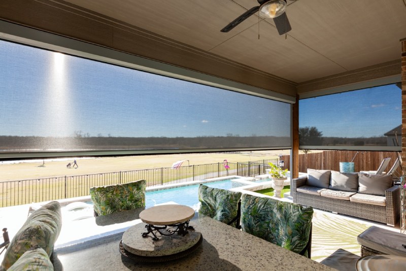 Outdoor patio with motorized solar shades.