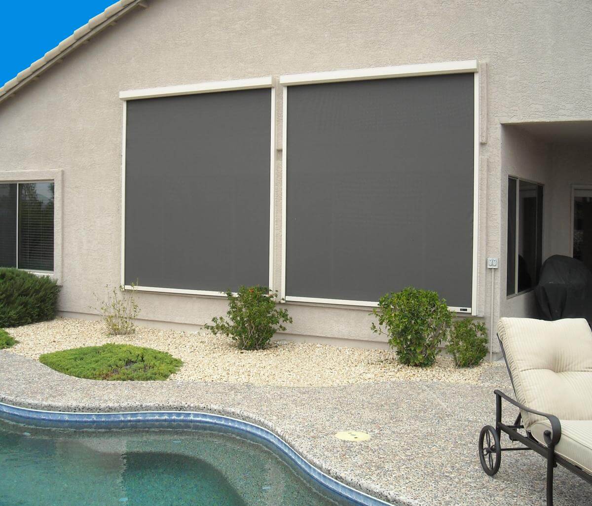 Outdoor patio with large grey motorized shades in Dallas-Fort Worth.