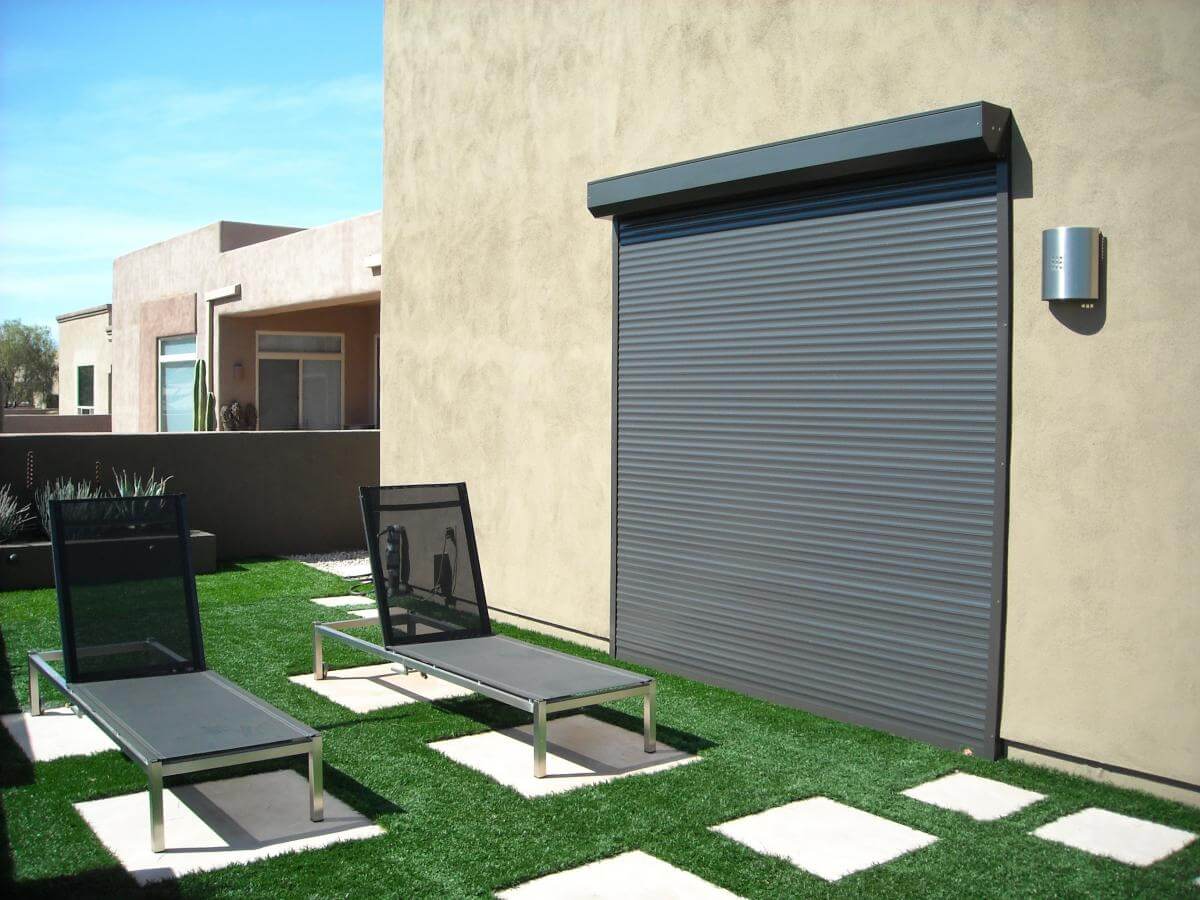 Outdoor roller shutter door, modern patio loungers.